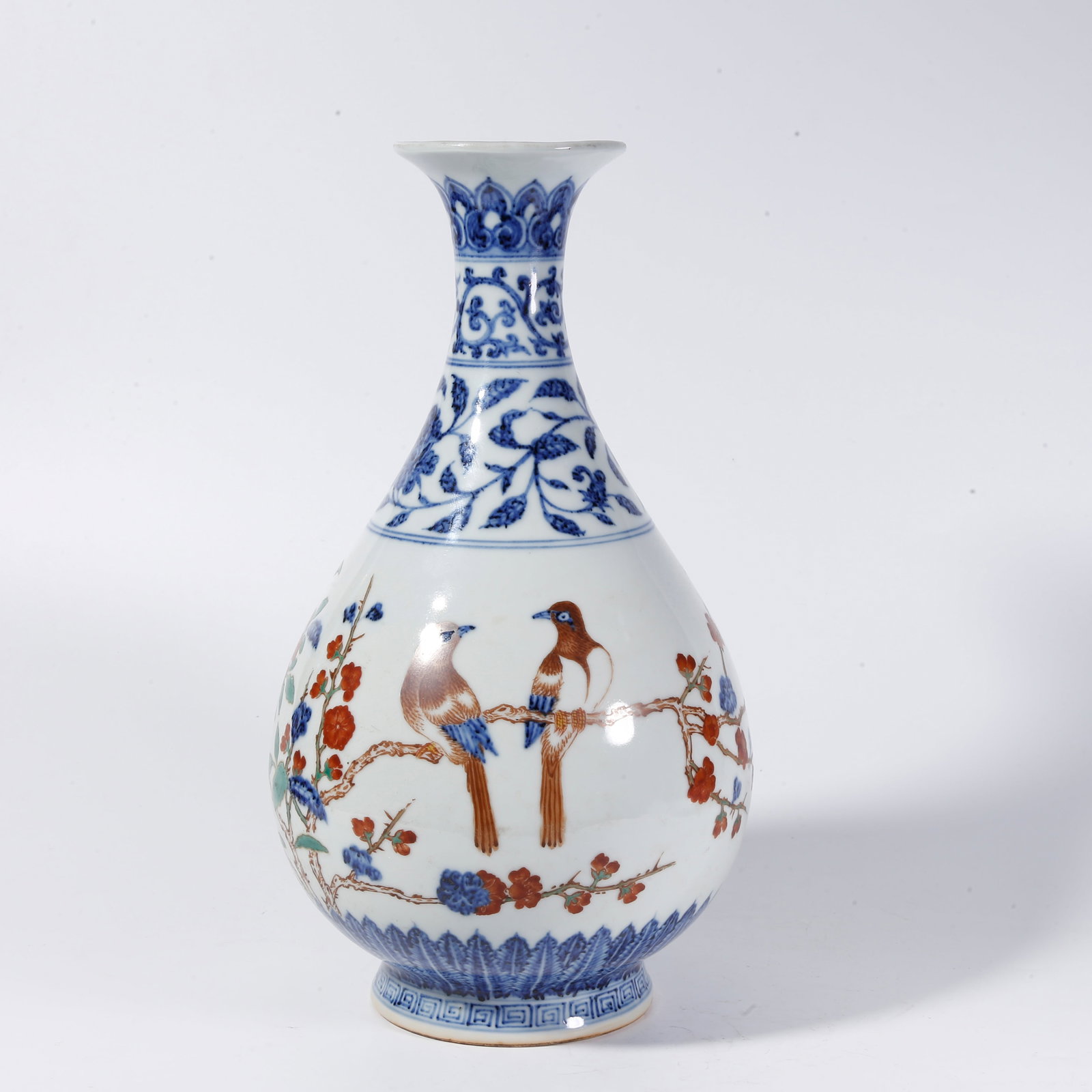 A BLUE-AND-WHITE UNDERGLAZE-RED JADE HU SPRING VASE WITH FLOWER-AND-BIRD MOTIFS: Blue-and-White Underglaze-Red Jade Hu Spring Vase with Flower-and-Bird Motifs