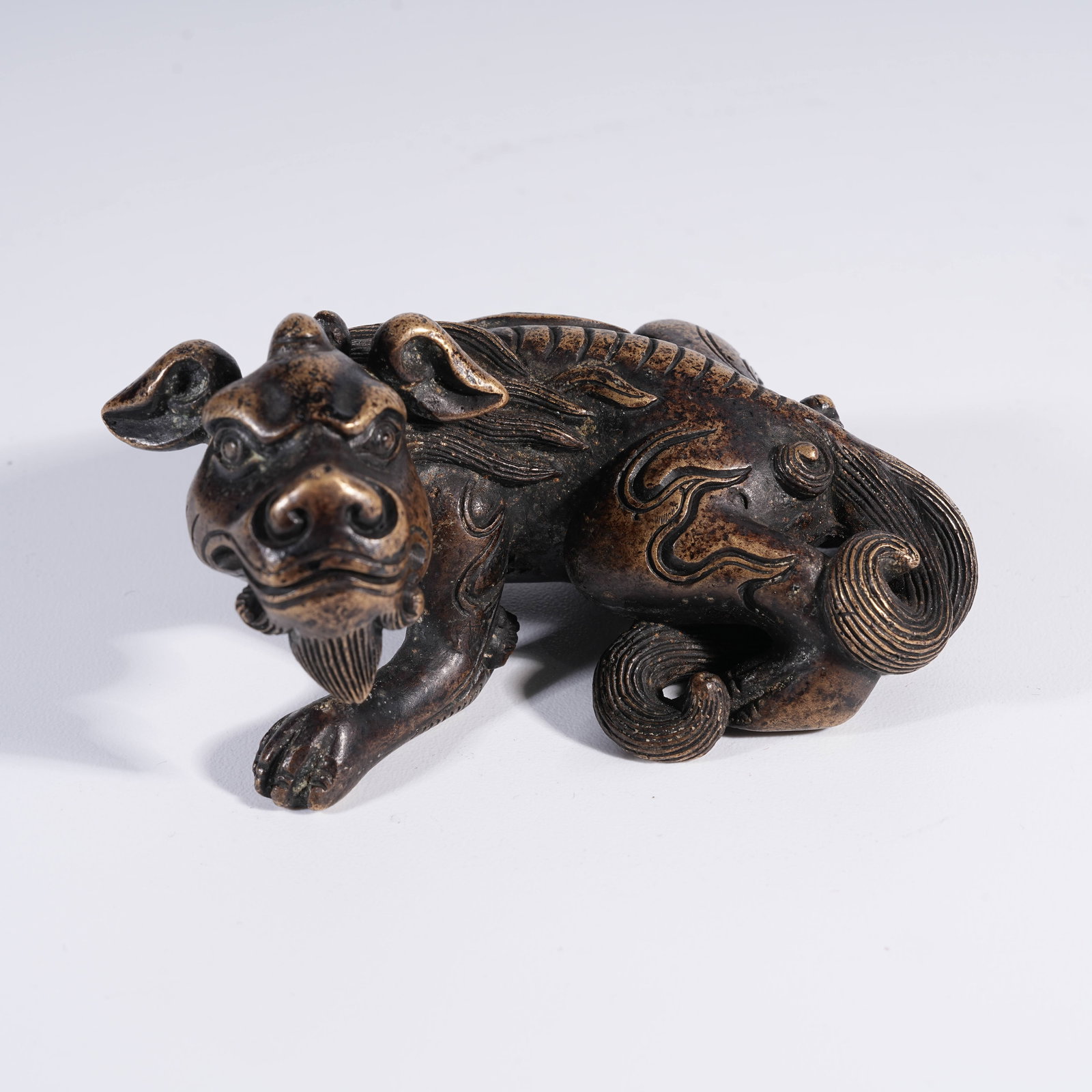A BRONZE AUSPICIOUS BEAST PAPERWEIGHT (1 of 8)