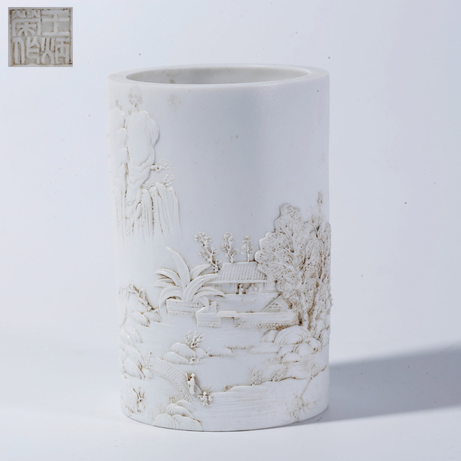 A WHITE-GLAZE BRUSH POT WITH LANDSCAPE AND FIGURE MOTIFS (1 of 9)