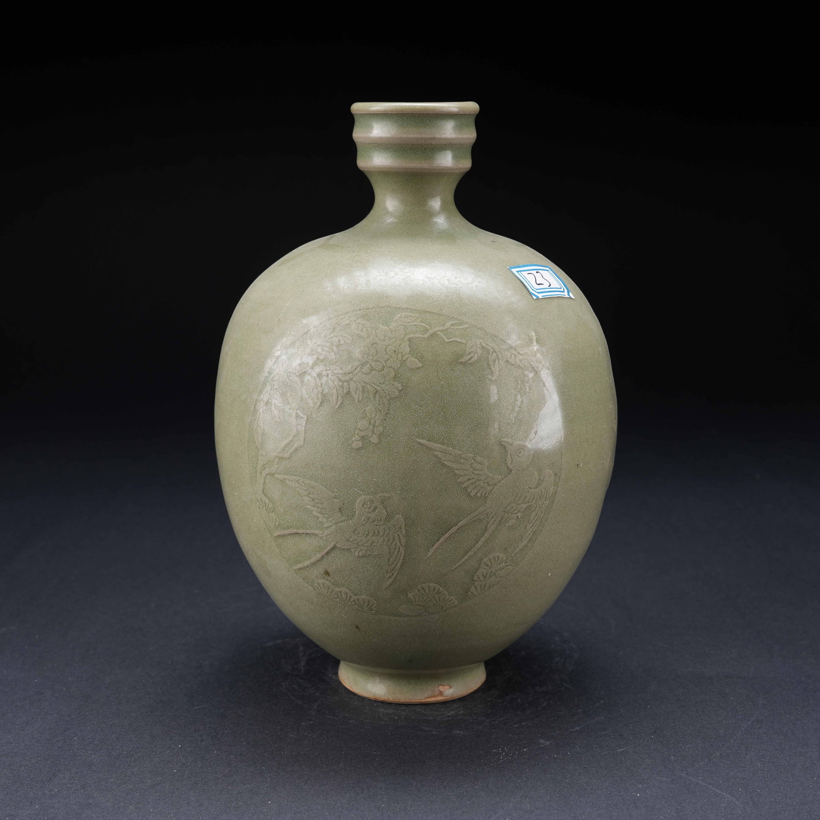 A FENCAI GLAZED BOTTLE WITH INCISED PINE AND CRANE LONGEVITY MOTIF: Fencai Glazed Bottle with Incised Pine and Crane Longevity Motif