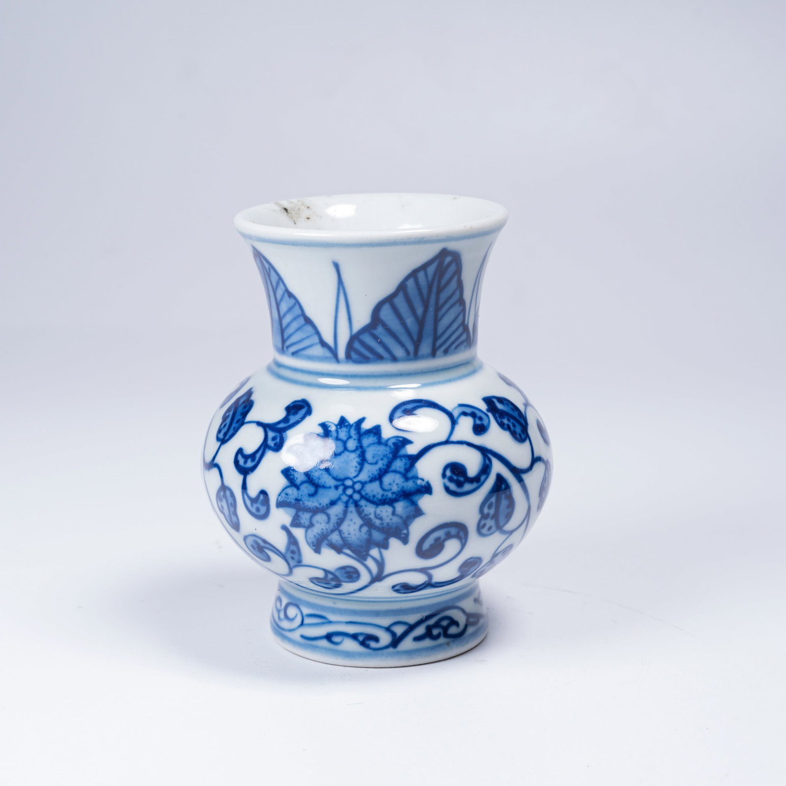 A BLUE-AND-WHITE VASE WITH SCROLLING FLORAL DESIGN (1 of 9)