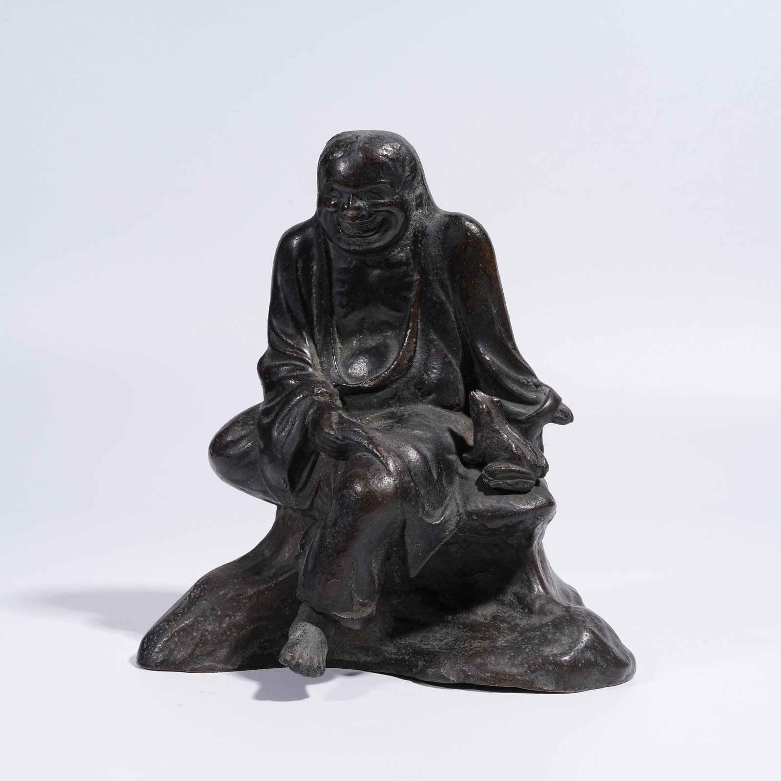 A BRONZE ORNAMENT: LIU HAI PLAYING WITH THE MONEY TOAD (1 of 8)