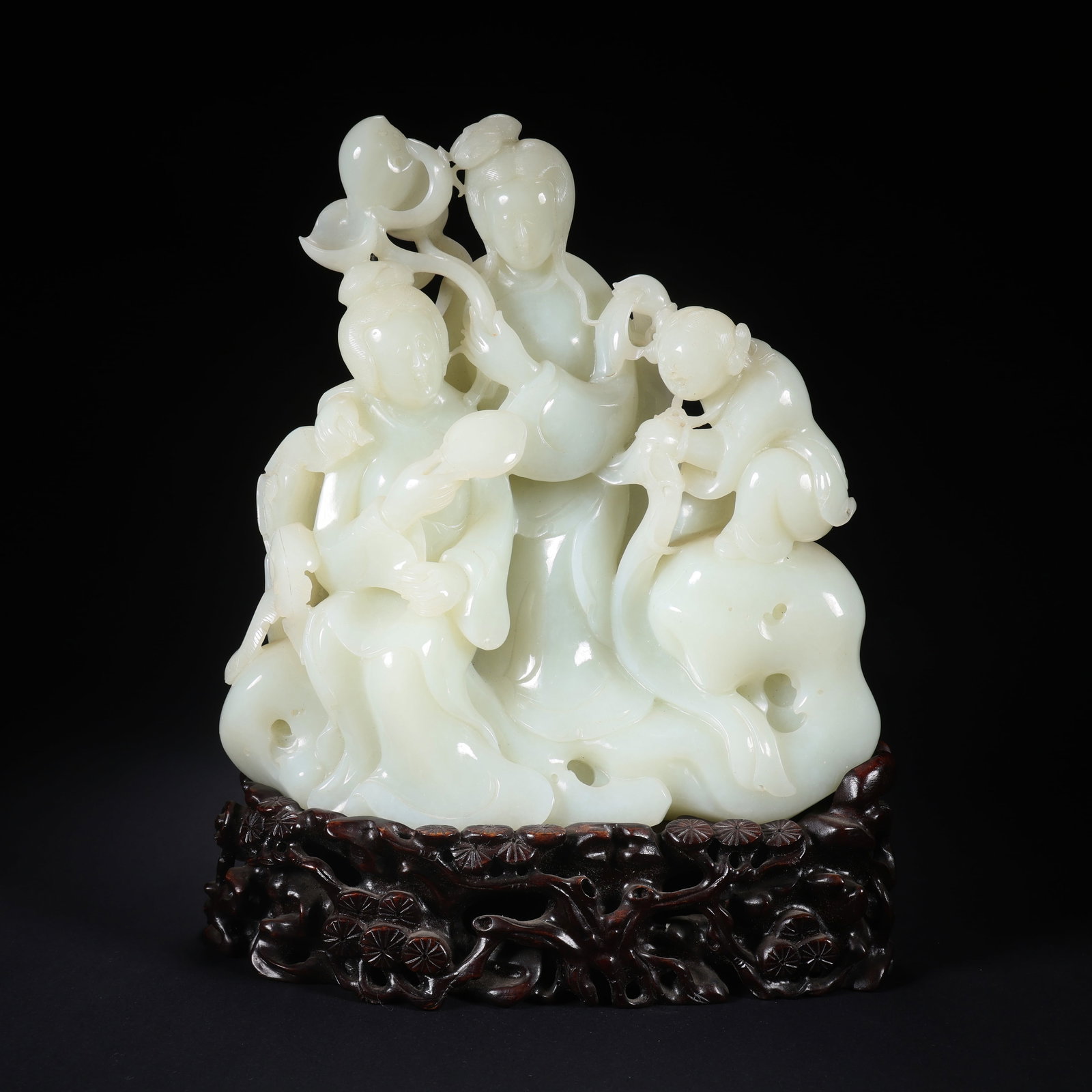 A HETIAN JADE DOUBLE GIRL PLAYING WITH CHILD ORNAMENT ON WOODEN BASE (1 of 9)