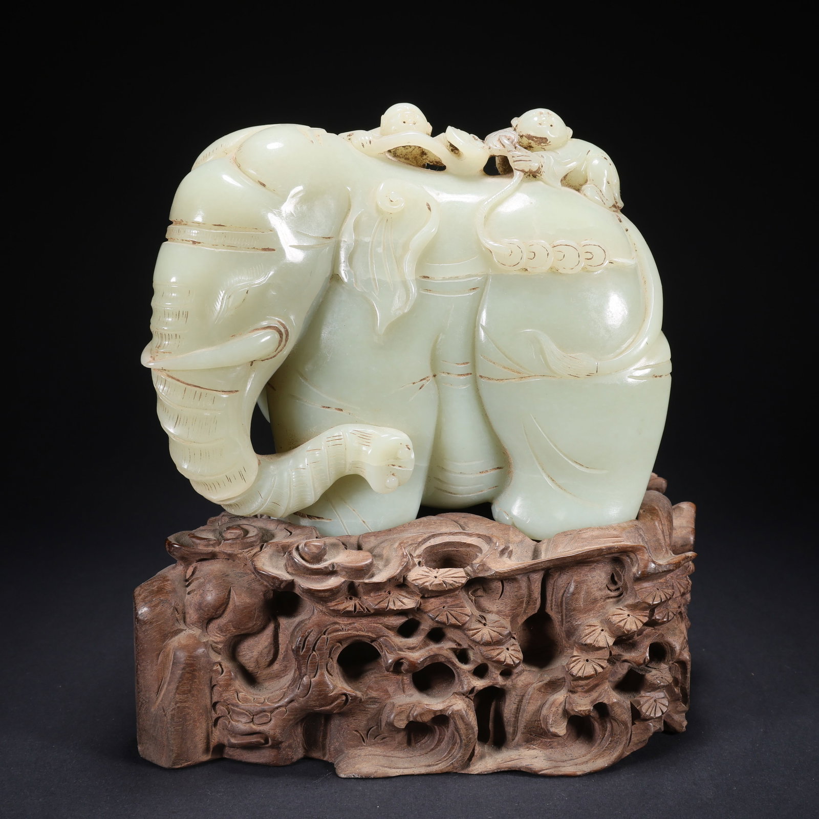 A HETIAN JADE BOY PLAYING WITH ELEPHANT ON WOODEN BASE (1 of 9)