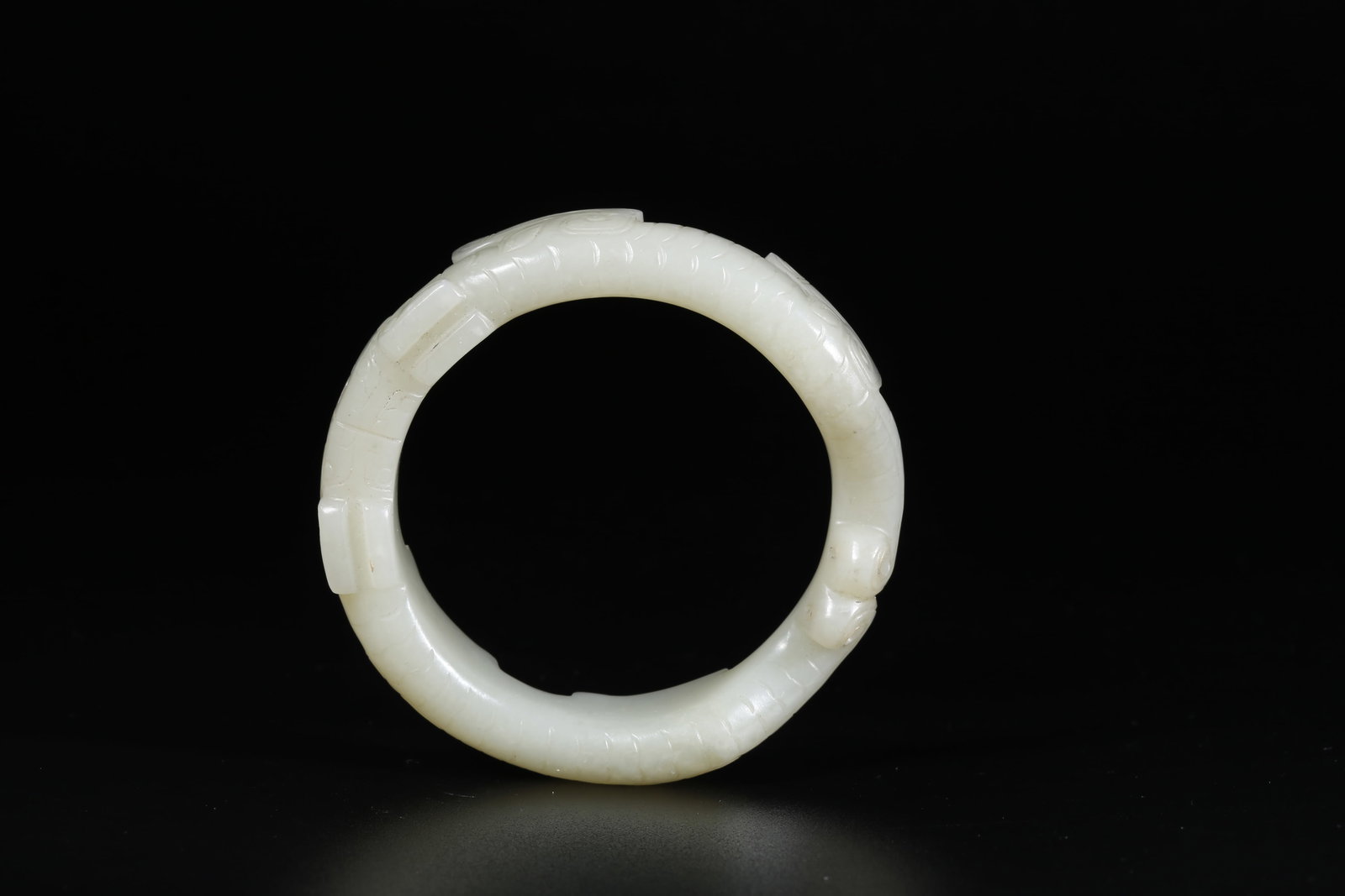 A HETIAN JADE CARVED BEAST-PATTERNED BRACELET (1 of 10)