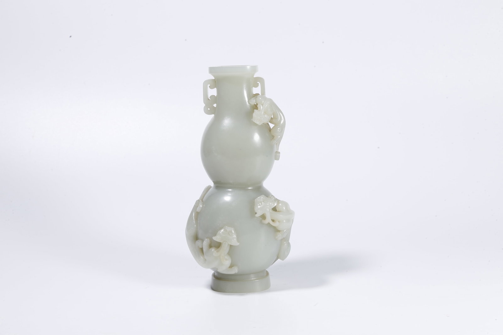 A HETIAN JADE DOUBLE-HANDLED GOURD-SHAPED VASE CARVED WITH DRAGON MOTIFS (1 of 10)