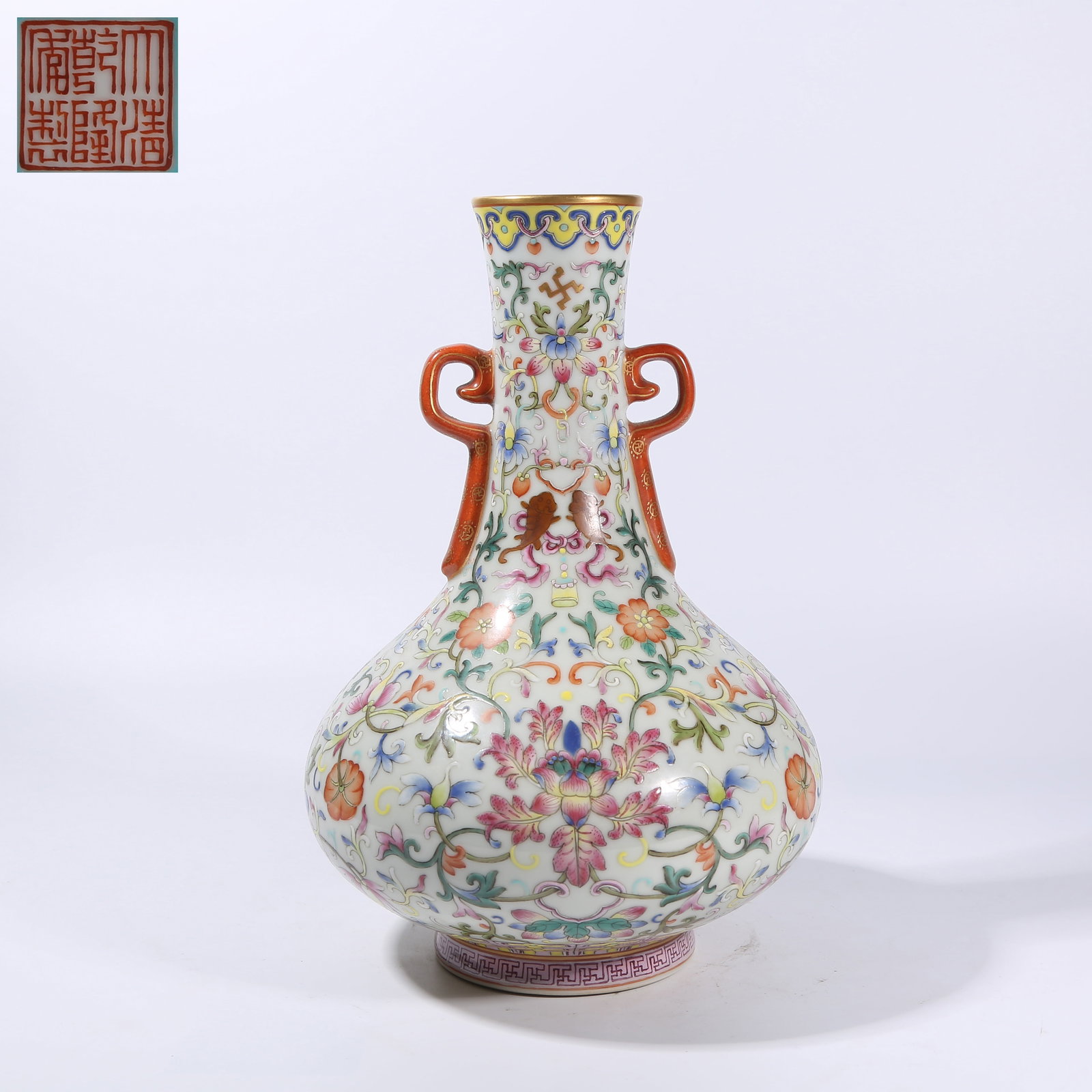A FAMILLE ROSE "INTERTWINED FLORAL" PATTERN RIBBON-HANDLED VASE: Famille rose "intertwined floral" pattern ribbon-handled vase