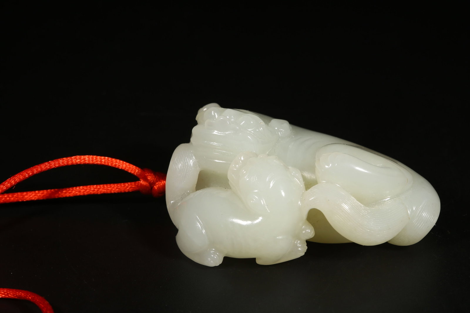 A HETIAN JADE PAIR OF ADULT AND YOUNG LION PENDANTS (1 of 8)