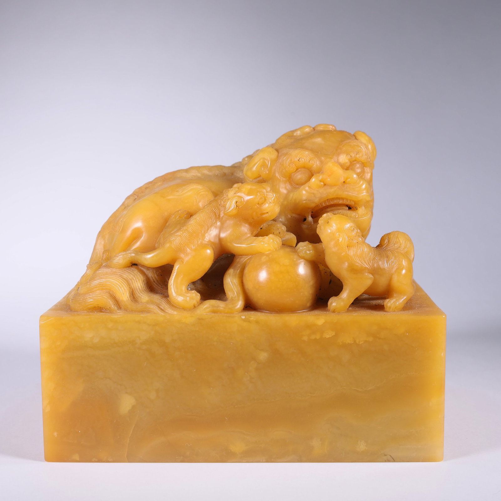 A TIANHUANG STONE RECTANGULAR SEAL WITH THREE LIONS PLAYING WITH SNOWBALL (1 of 9)