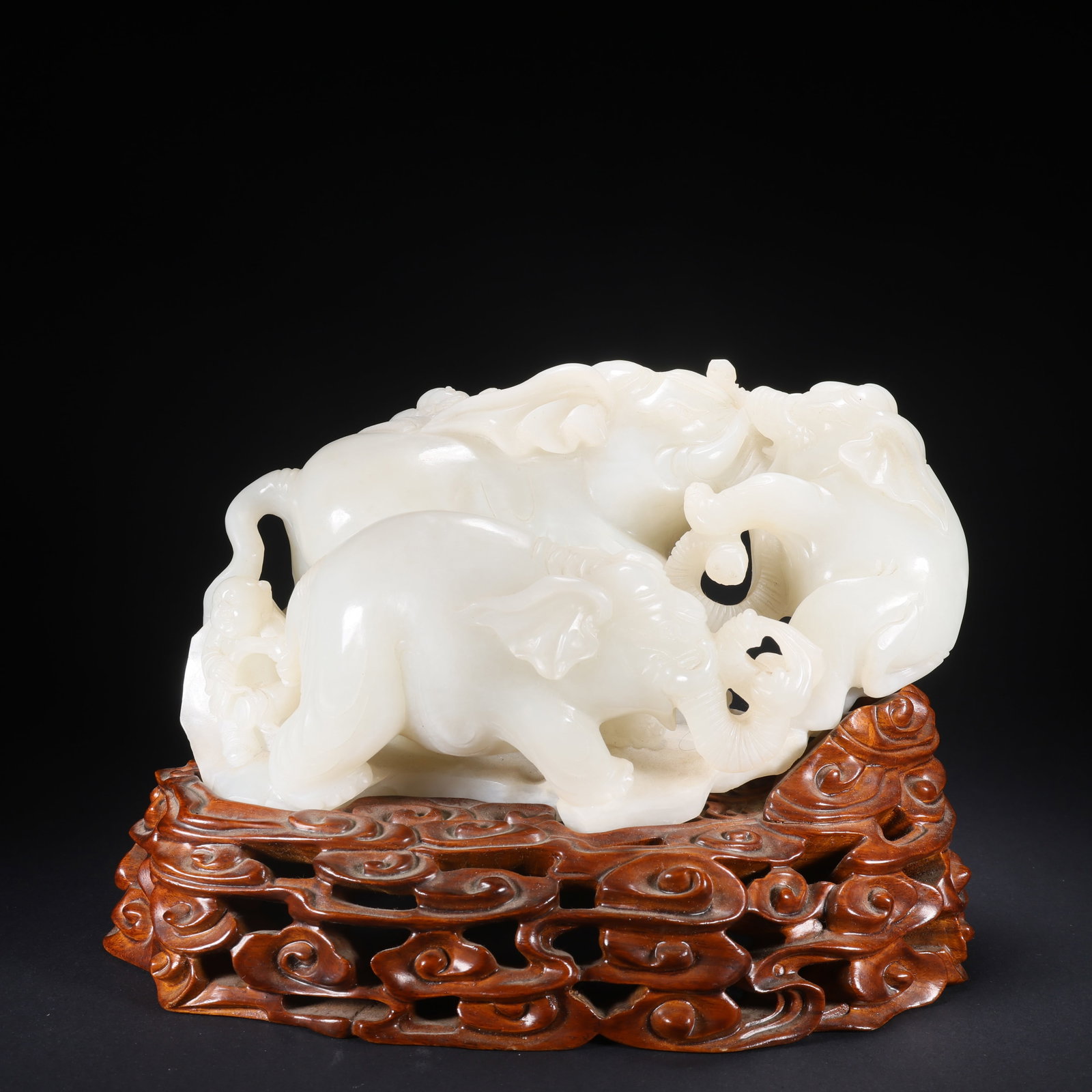 A HETIAN JADE BOY PLAYING WITH ELEPHANT ON WOODEN BASE (1 of 9)