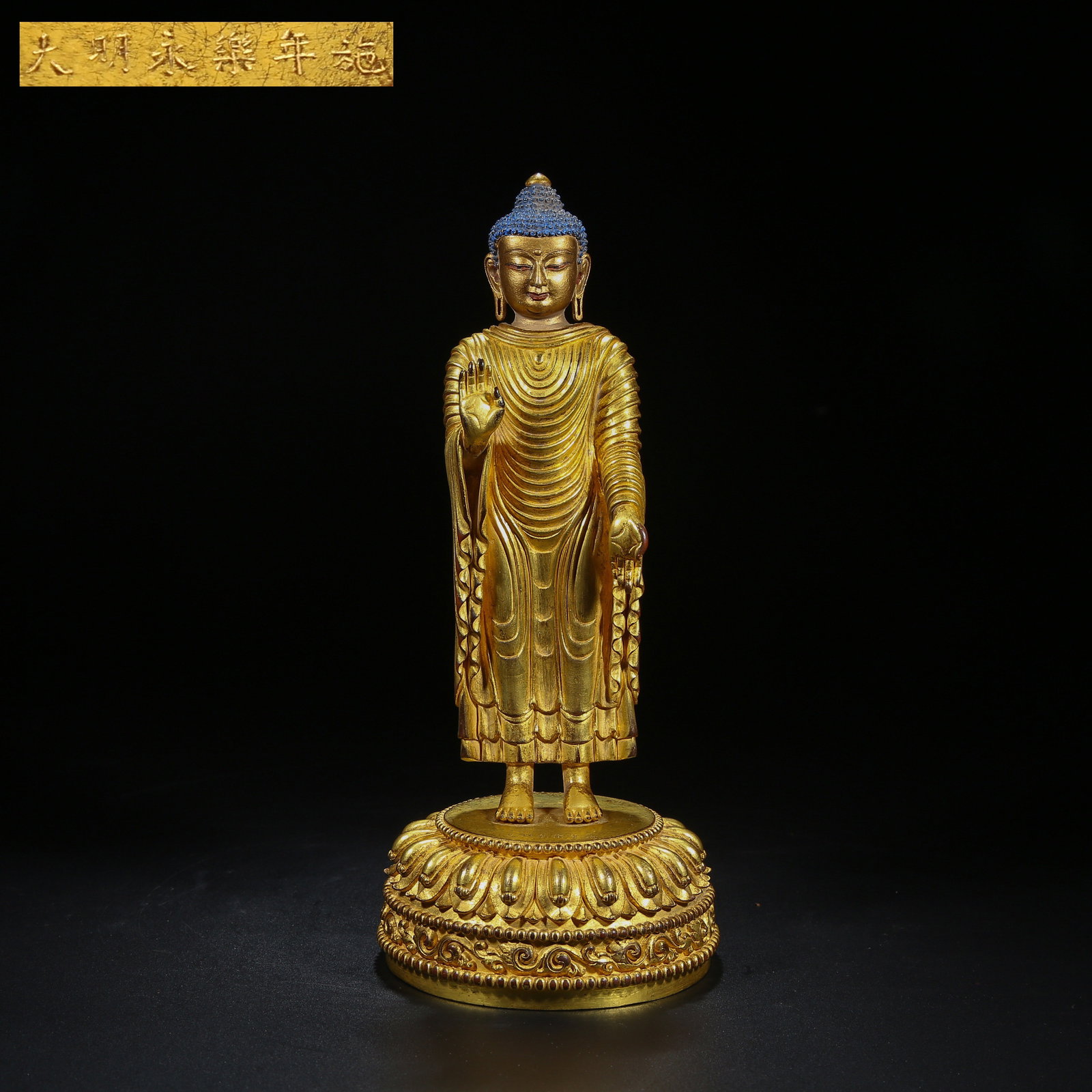 A GILT BRONZE STANDING GUIDING BUDDHA STATUE (1 of 9)