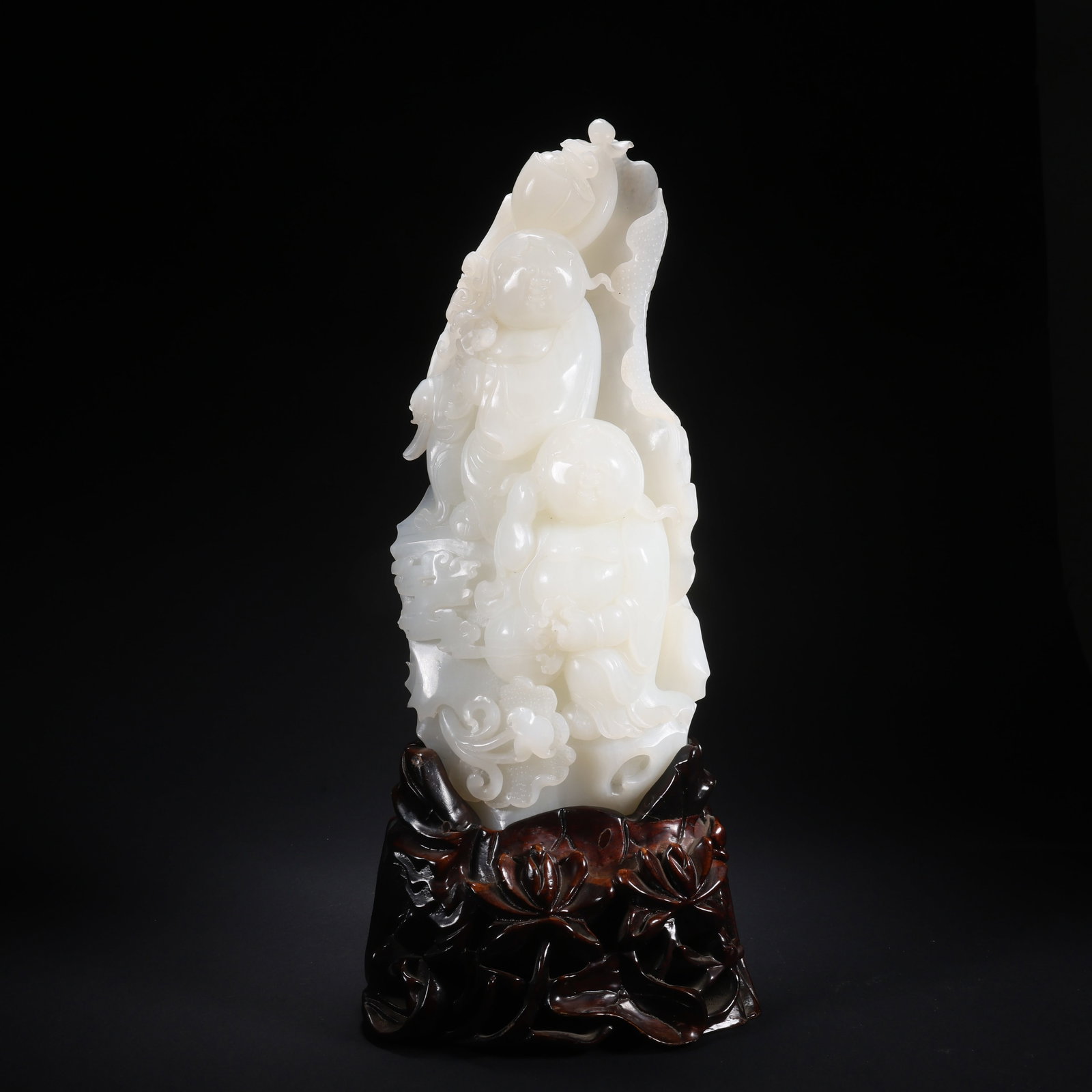 A HETIAN JADE "HEHE ERXIAN" (IMMORTALS OF HARMONY) ON WOODEN BASE (1 of 9)