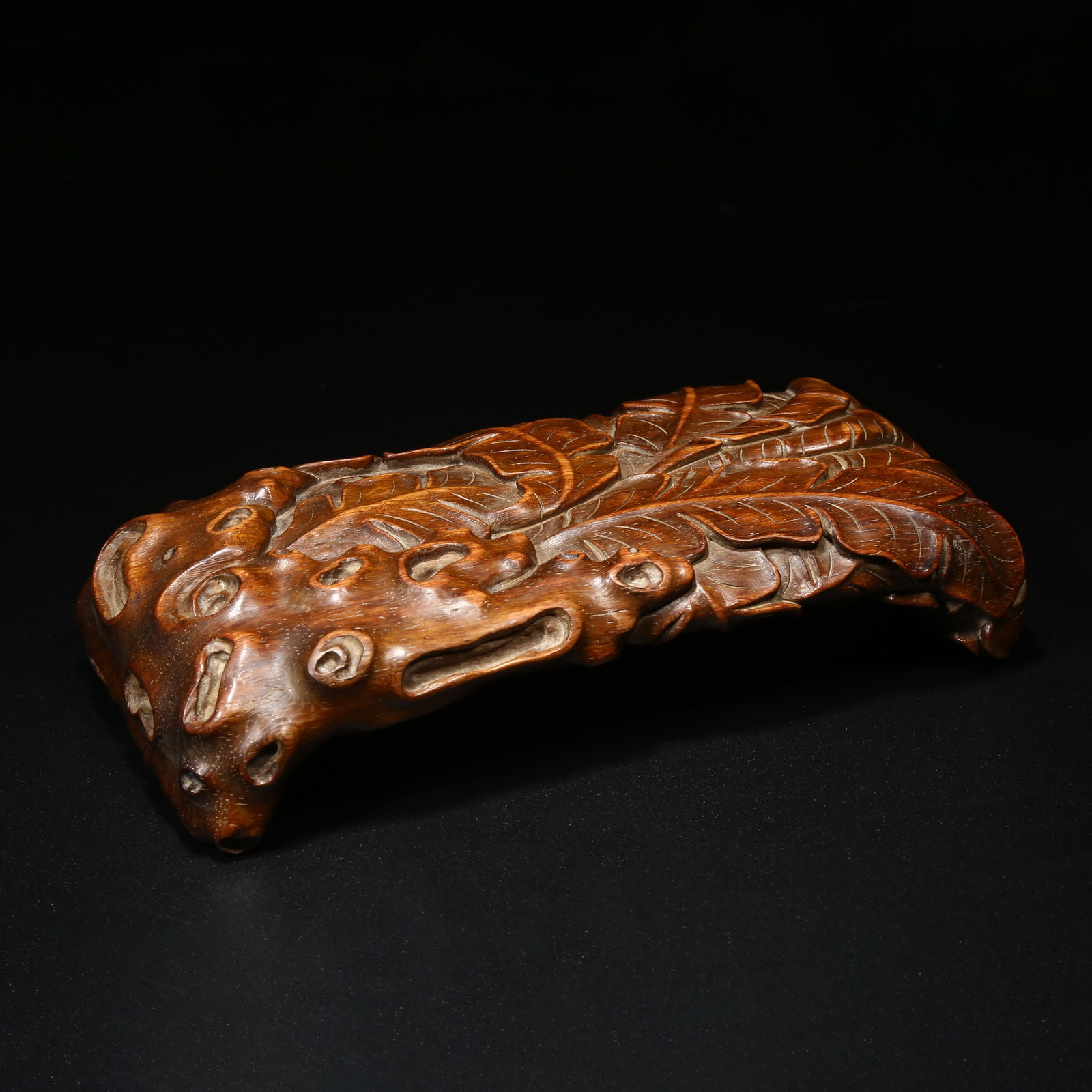 A HUANGHUALI INKSTONE STAND WITH BANANA LEAF AND CAVE STONE MOTIFS (1 of 8)