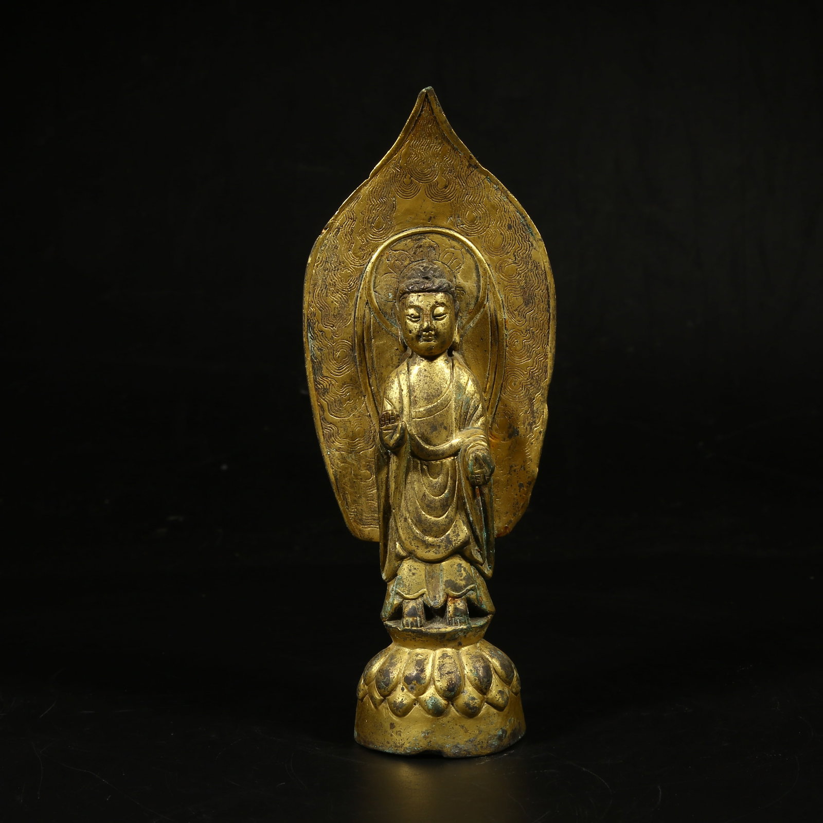 A GILT-BRONZE STANDING FIGURE OF SHAKYAMUNI (1 of 8)