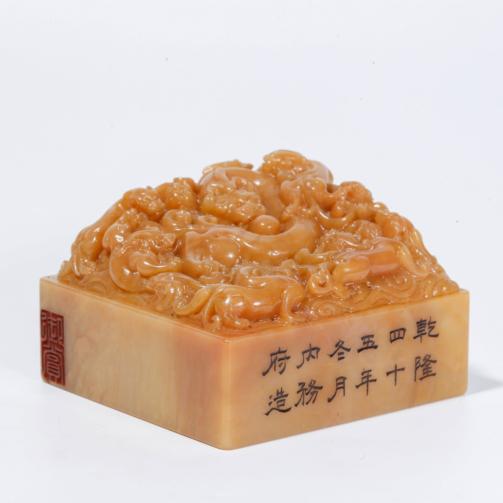 A SHOUSHAN TIANHUANG STONE SEAL WITH NINE-DRAGON MOTIF: Shoushan Tianhuang Stone Seal with Nine-Dragon Motif