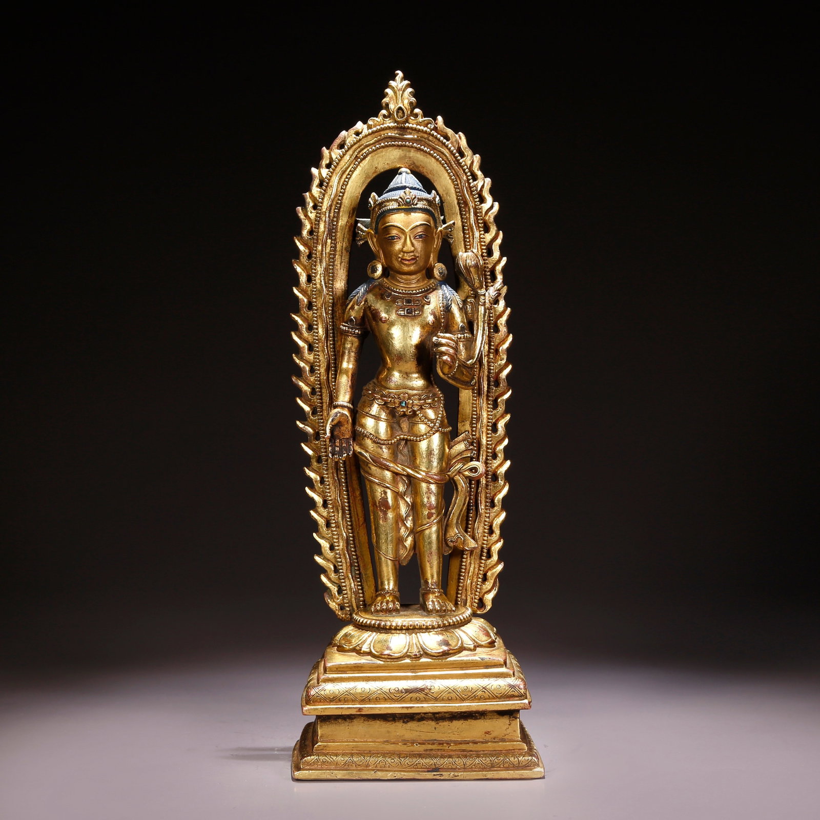 A GILT-BRONZE STANDING GUANYIN HOLDING LOTUS: Gilt-Bronze Standing Guanyin Holding Lotus