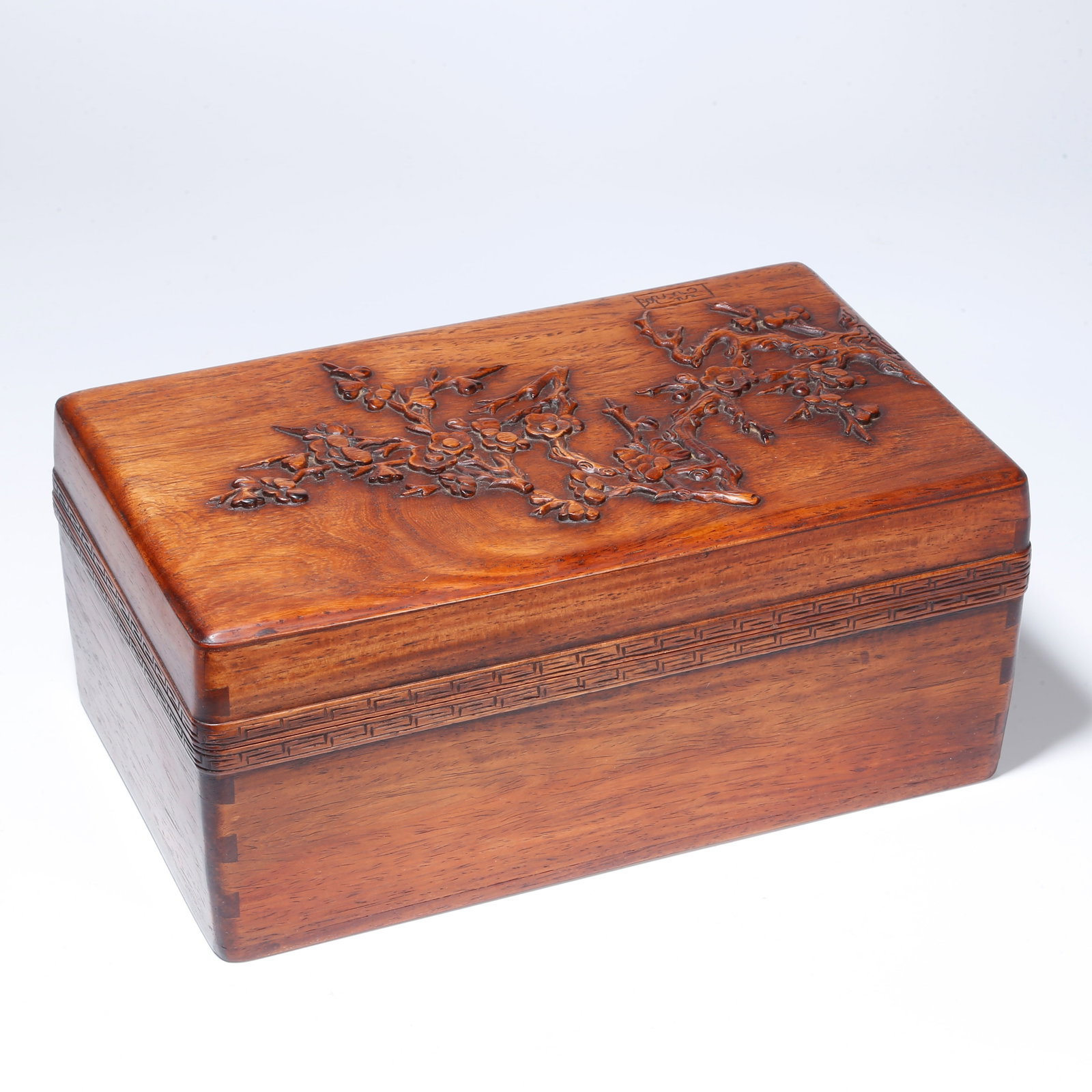 A HUANGHUALI LIDDED BOX WITH PLUM BLOSSOM DESIGN: Huanghuali Lidded Box with Plum Blossom Design