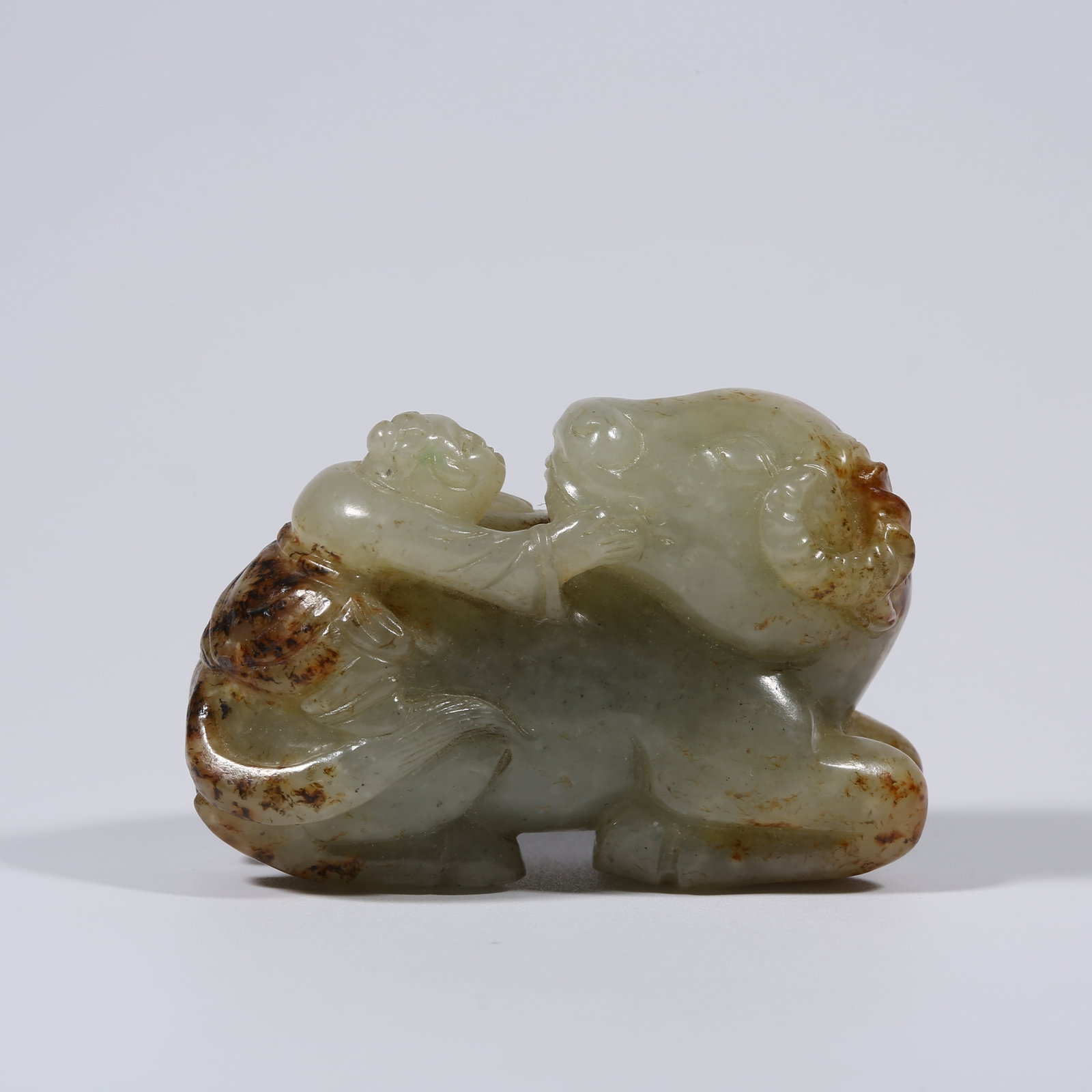 A HETIAN JADE CHILD HERDING OX ORNAMENT: Hetian Jade Child Herding Ox Ornament
