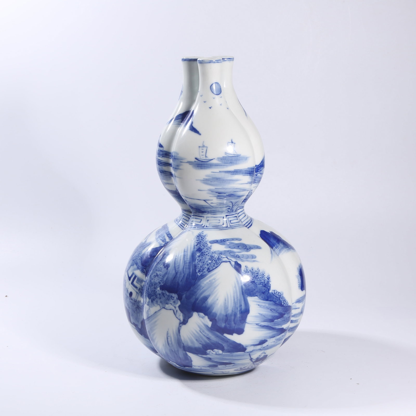 A BLUE-AND-WHITE FIGURE-AND-STORY THREE-HOLED GOURD VASE (1 of 10)