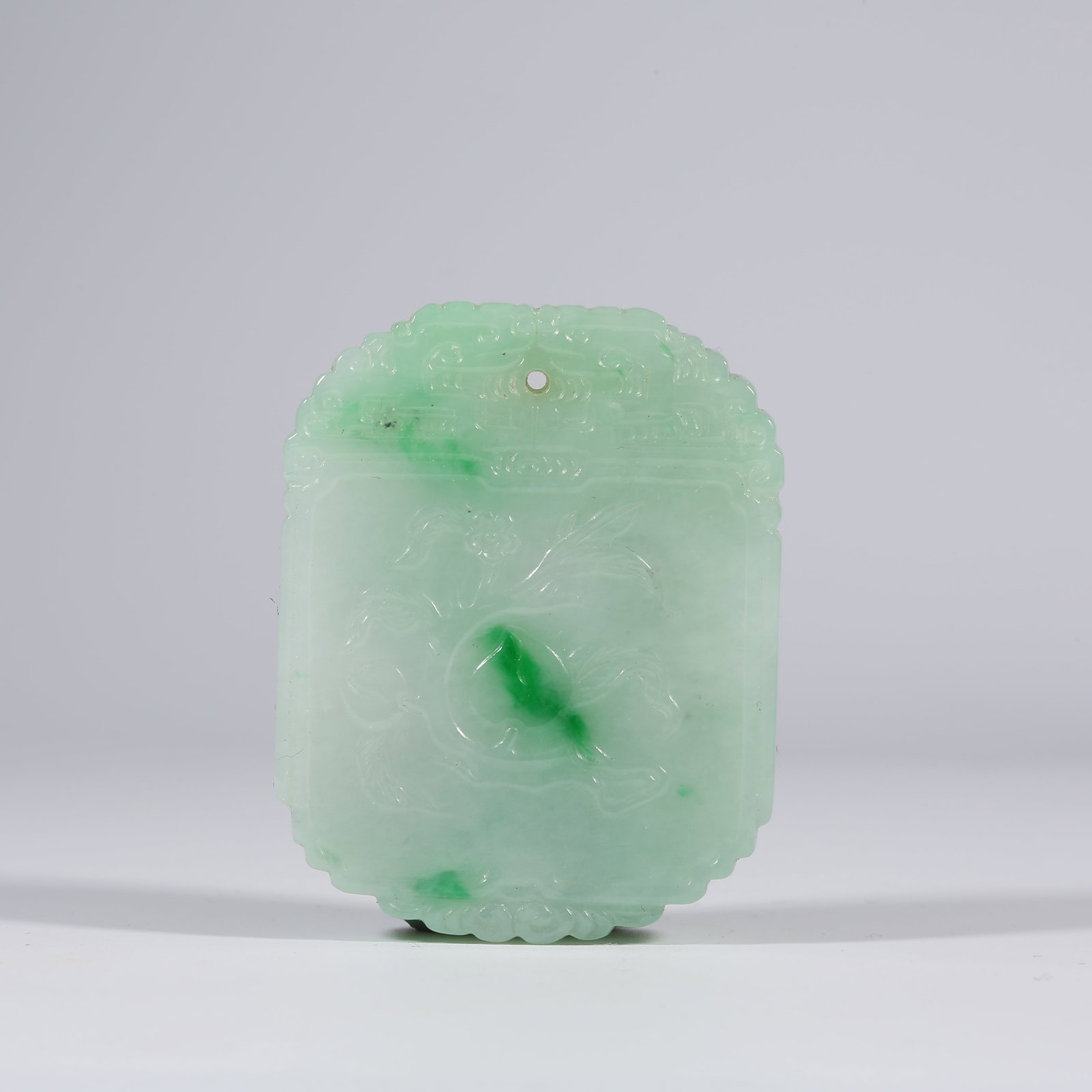 A JADEITE PENDANT WITH LONGEVITY PEACH PATTERN: Jadeite Pendant with Longevity Peach Pattern