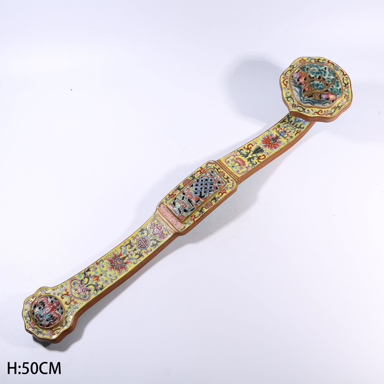 A YELLOW-GROUND FAMILLE ROSE TREASURE-FLOWER PATTERNED RUYI: Yellow-ground famille rose treasure-flower patterned ruyi