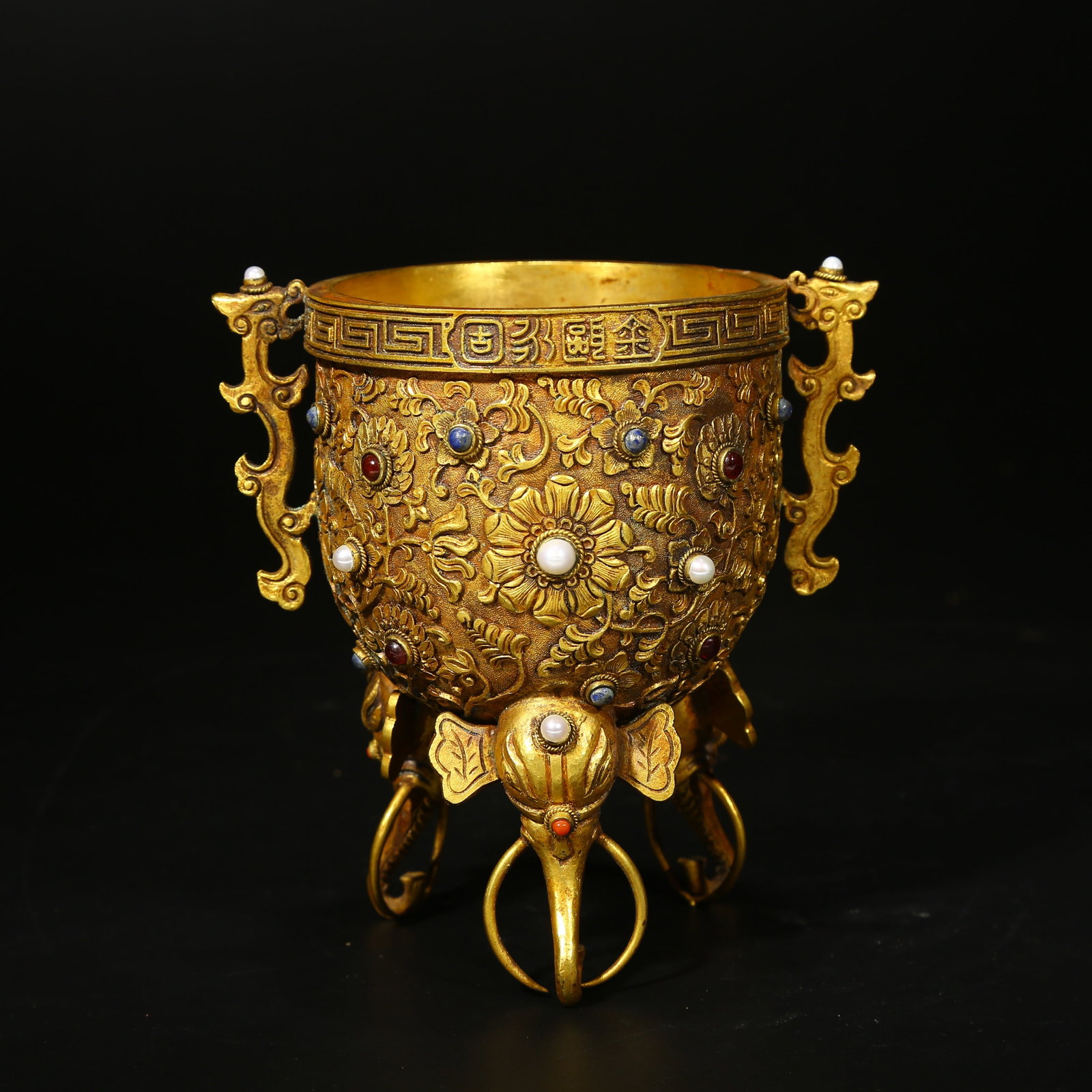 A GILT BRONZE YONGGU CUP INLAID WITH GEMSTONES: Gilt bronze Yonggu cup inlaid with gemstones