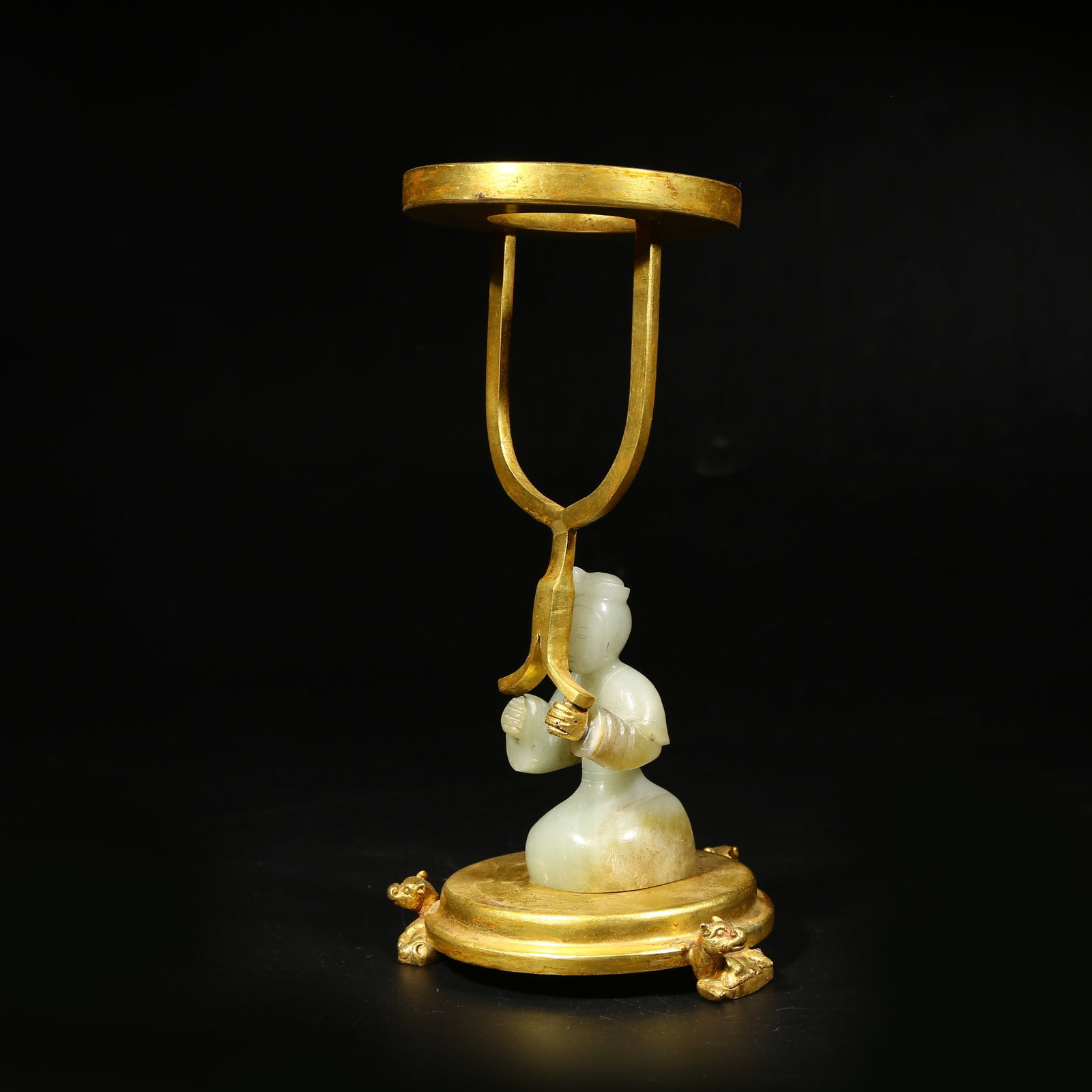 A ARCHAIC JADE CANDLE HOLDER IN THE FORM OF A HUMAN FIGURINE: Archaic jade candle holder in the form of a human figurine