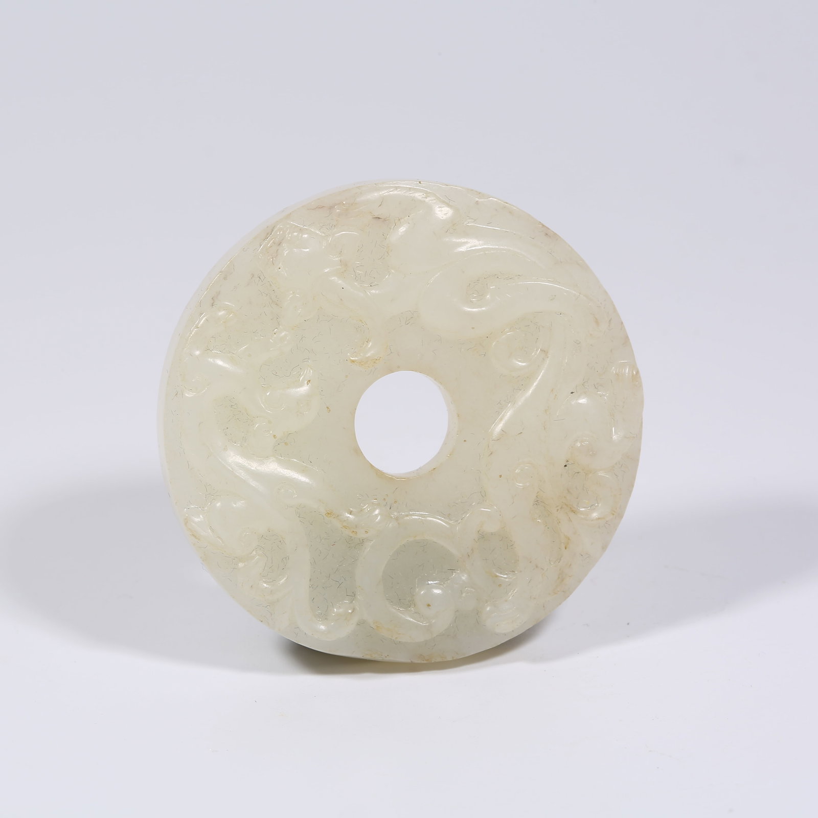 A HETIAN WHITE JADE BI DISK WITH CHI-DRAGON MOTIF (1 of 7)
