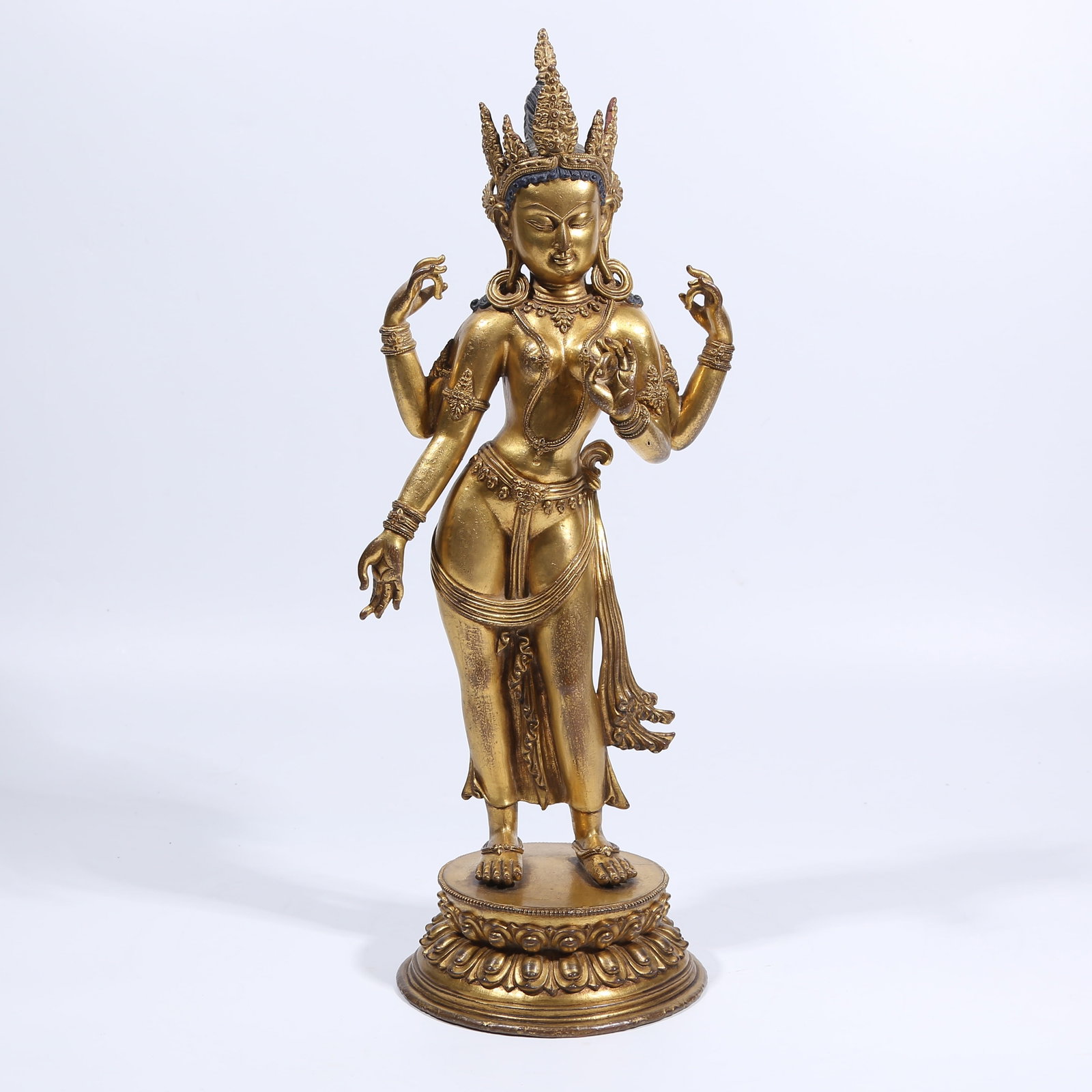 A GILT BRONZE FOUR-ARMED BODHISATTVA STANDING STATUE: Gilt Bronze Four-Armed Bodhisattva Standing Statue