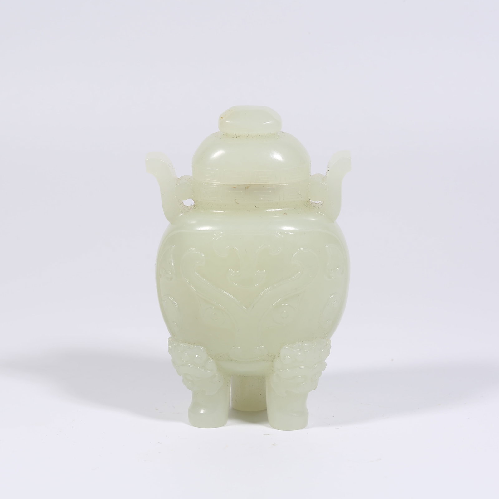 A HETIAN WHITE JADE TRIPOD-STYLE SMALL CENSER WITH BEAST FACE MOTIF: Hetian White Jade Tripod-Style Small Censer with Beast Face Motif