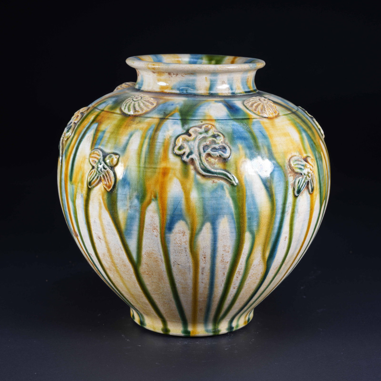 A PLAIN SANCAI CARVED JAR WITH FLOWER AND BUTTERFLY PATTERN: Plain Sancai Carved Jar with Flower and Butterfly Pattern
