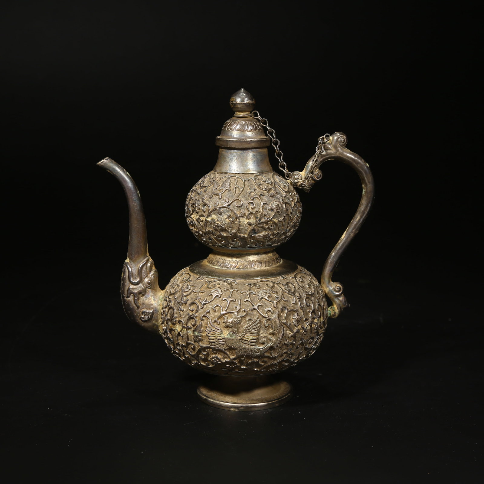 A SILVER PIERCED FLOWER AND PHOENIX-PATTERNED GOURD-SHAPED EWER: Silver pierced flower and phoenix-patterned gourd-shaped ewer