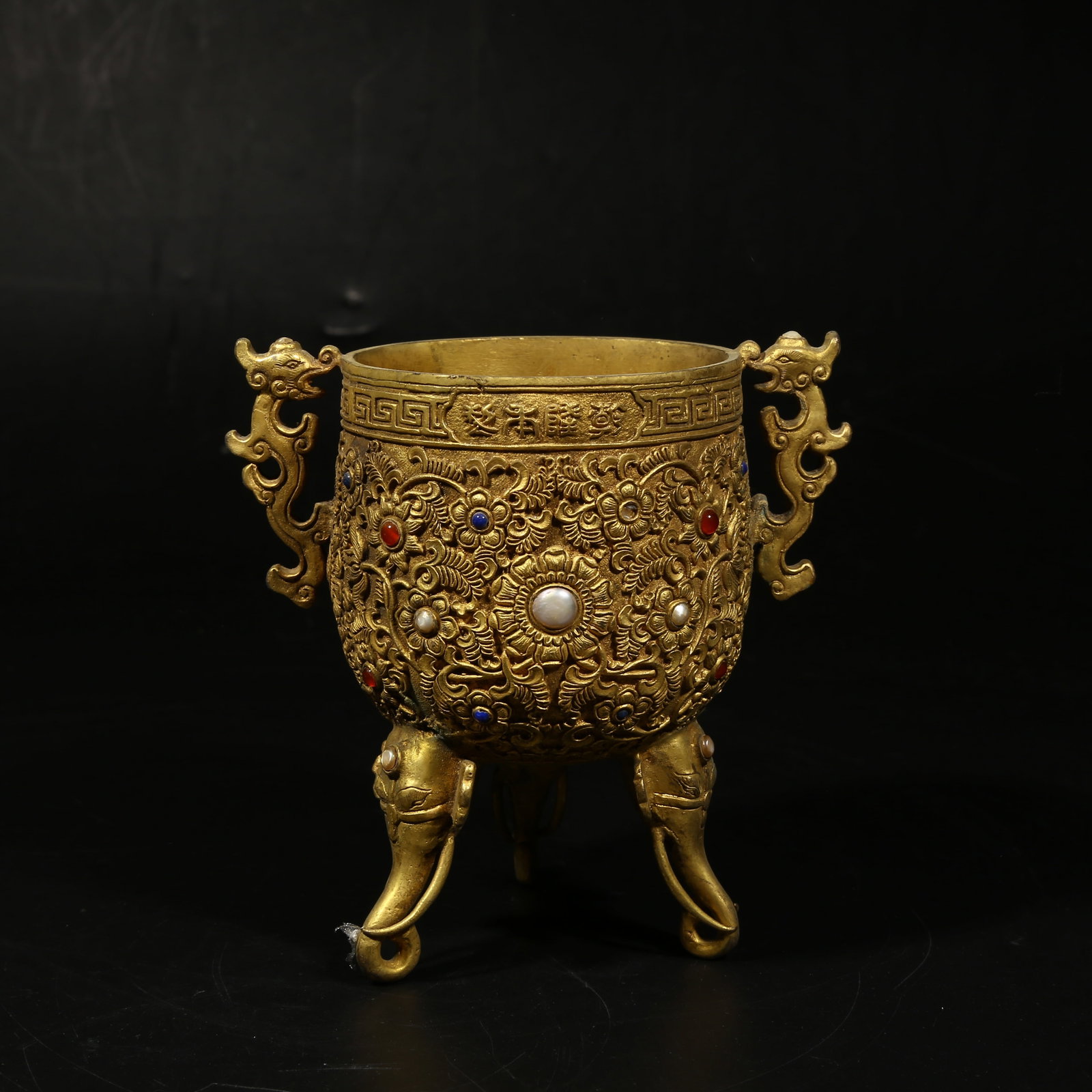 A GILDED BRONZE YONGGU CUP INLAID WITH GEMS: Gilded bronze Yonggu cup inlaid with gems