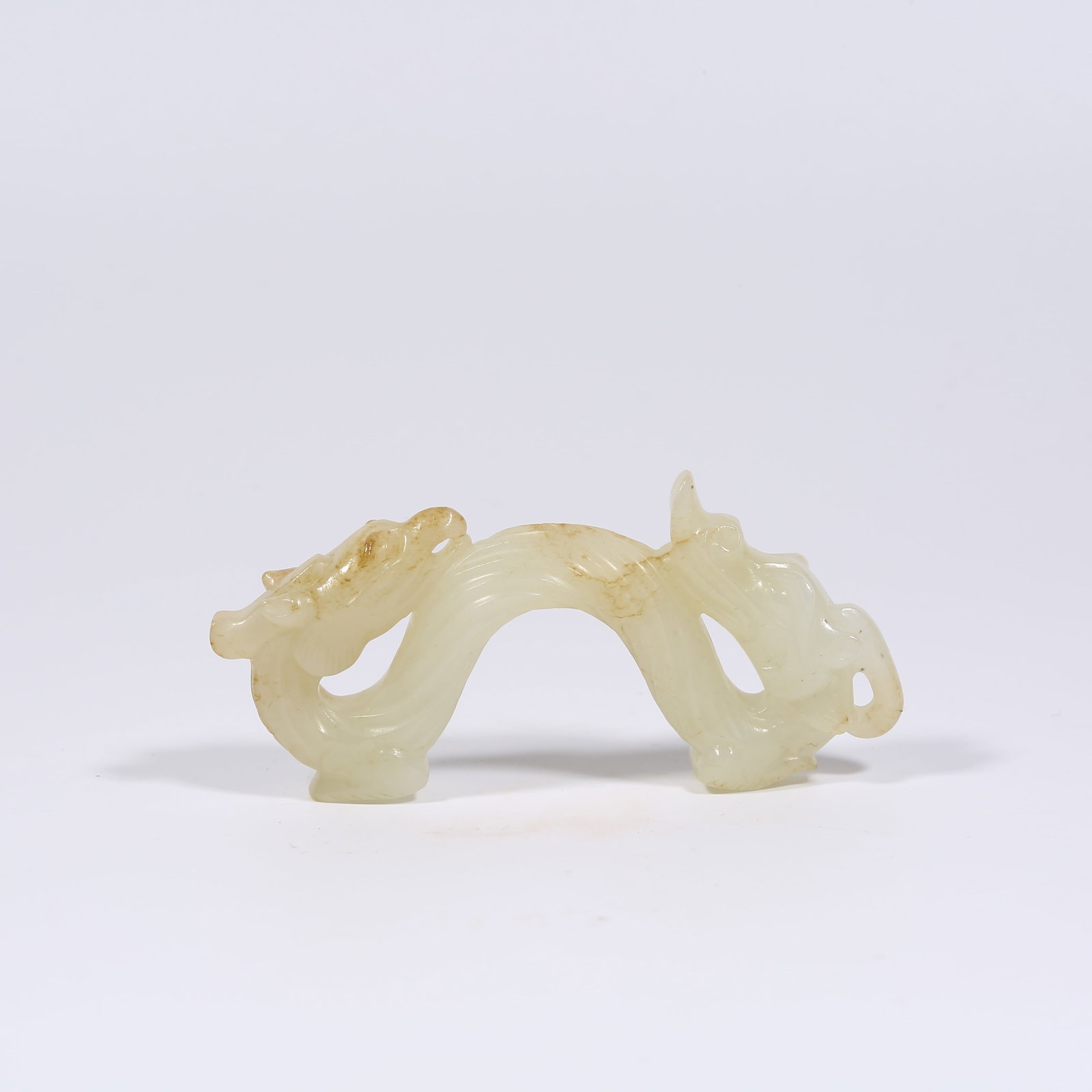 A HETIAN JADE PENDANT WITH DRAGON MOTIF: Hetian Jade Pendant with Dragon Motif