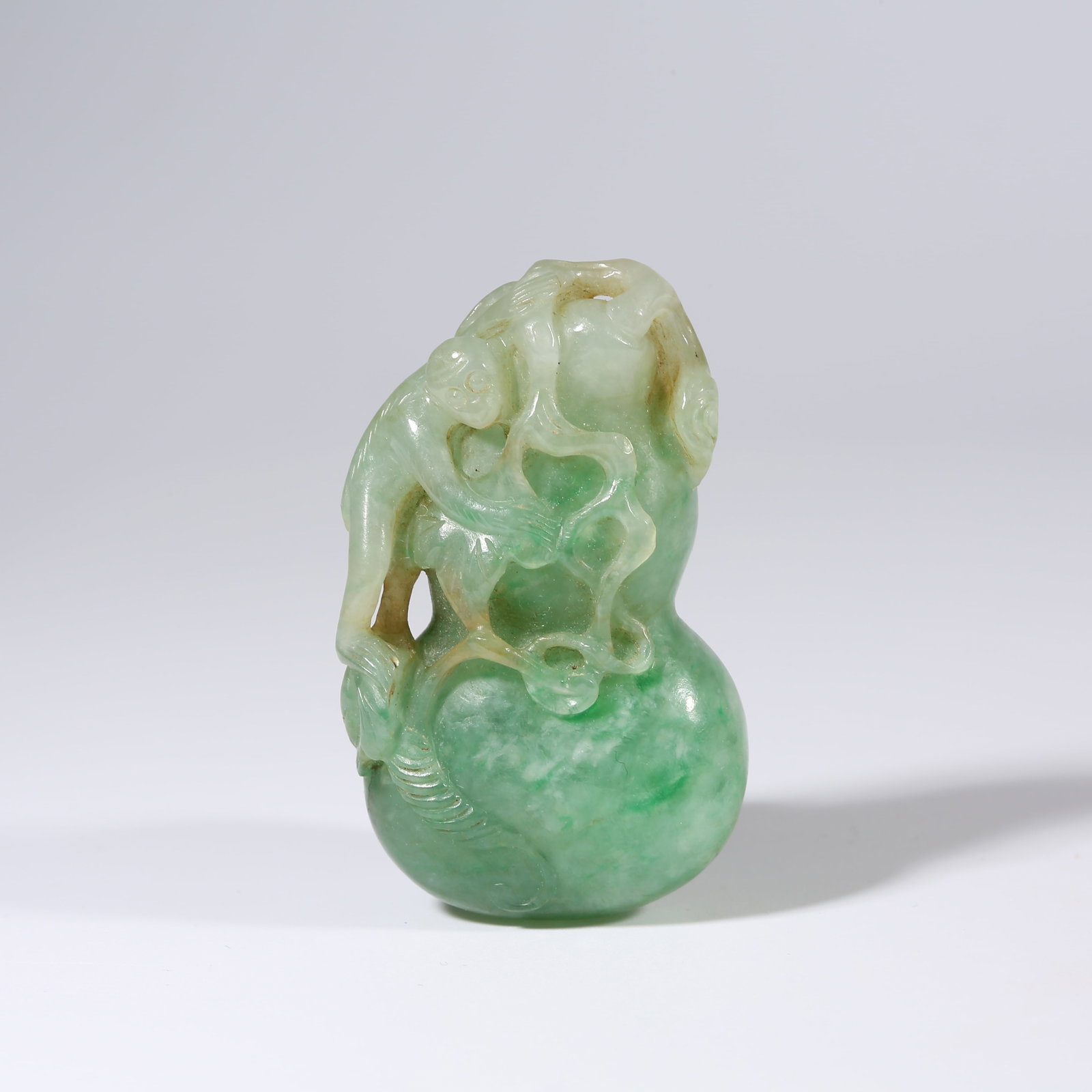 A JADEITE MONKEY OFFERING LONGEVITY PENDANT: Jadeite Monkey Offering Longevity Pendant