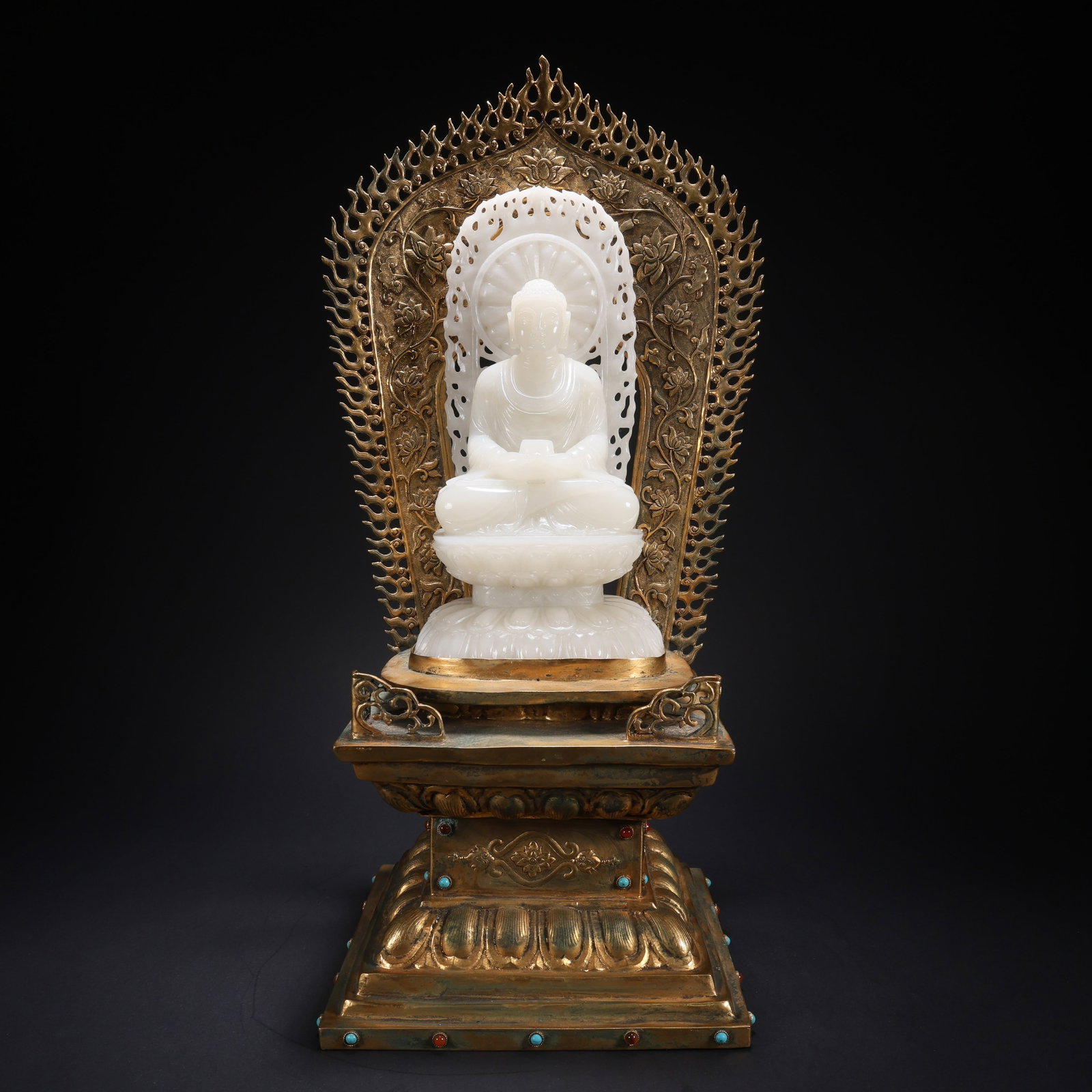 A HETIAN JADE GILDED BRONZE INLAID GEM BASE LOTUS-SEAT SEATED BUDDHA: Hetian Jade Gilded Bronze Inlaid Gem Base Lotus-Seat Seated Buddha