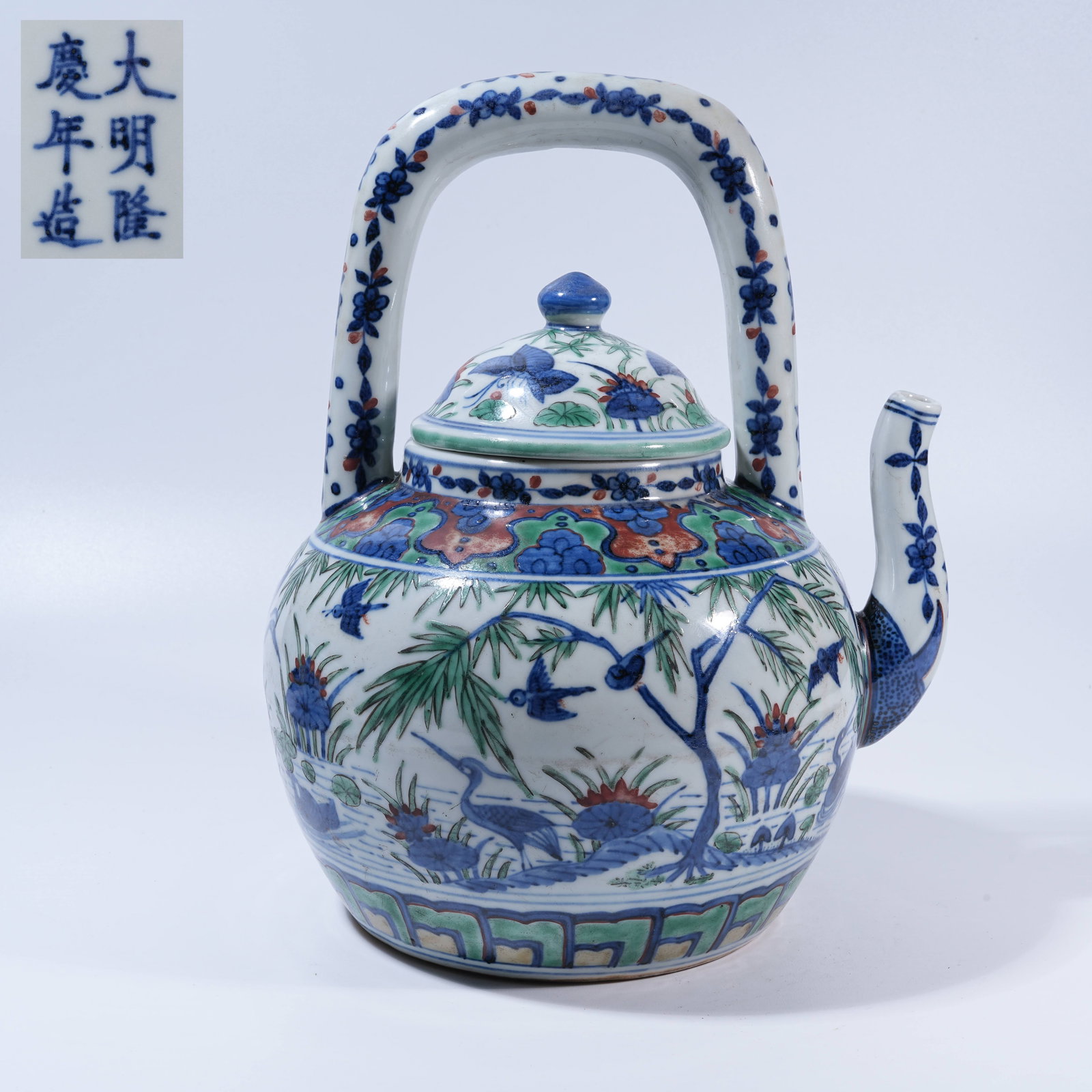 A BLUE-AND-WHITE WITH RED-AND-GREEN ENAMEL EWER WITH LOTUS POND SCENE: Blue-and-White with Red-and-Green Enamel Ewer with Lotus Pond Scene