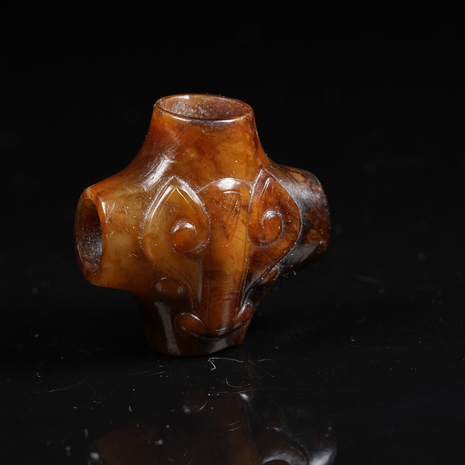 A ANCIENT JADE FOUR-WAY ORNAMENT WITH DEITY MASK PATTERN: Ancient Jade Four-way Ornament with Deity Mask Pattern