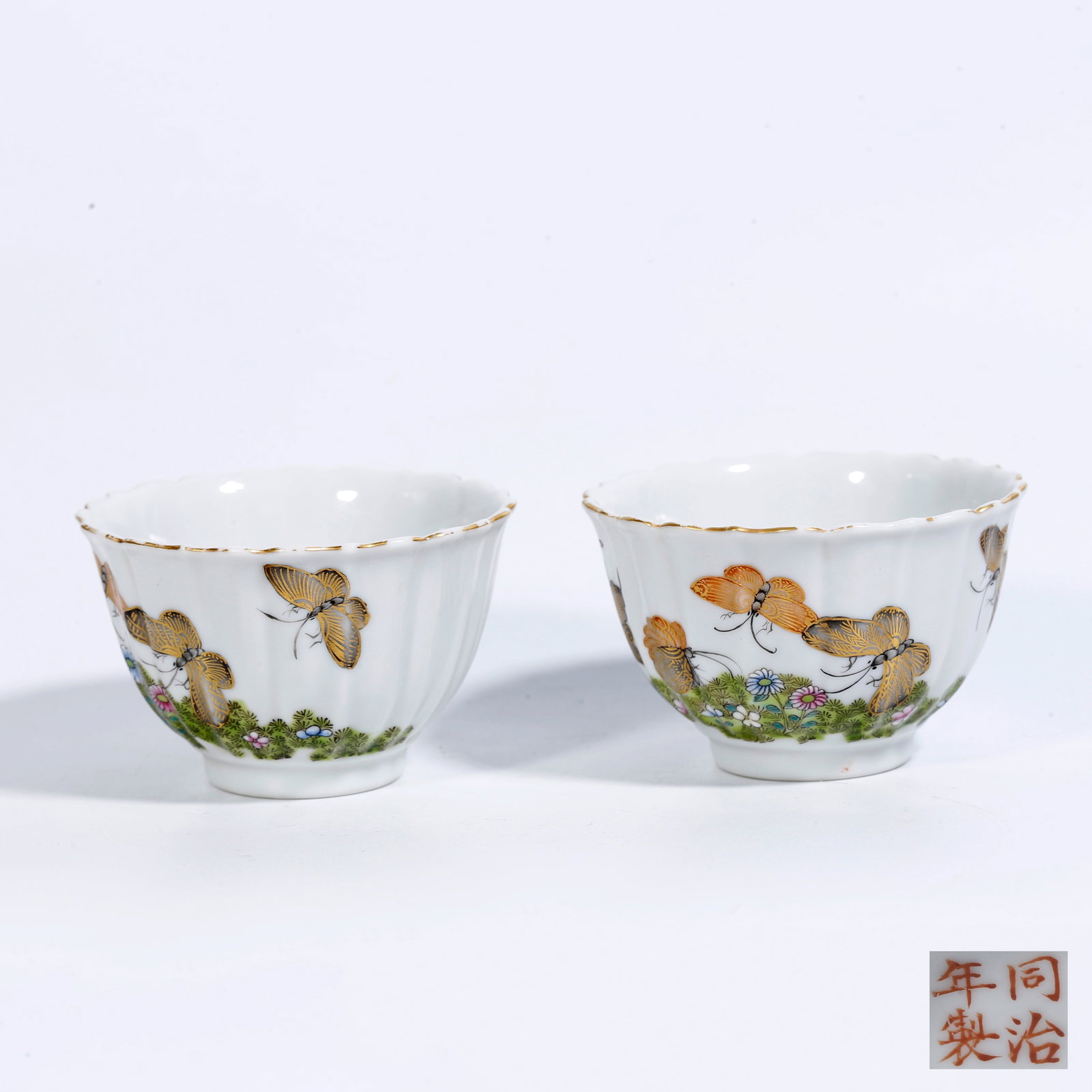A FAMILLE-ROSE CUPS WITH FLOWER-AND-BUTTERFLY MOTIFS (PAIR) (1 of 9)