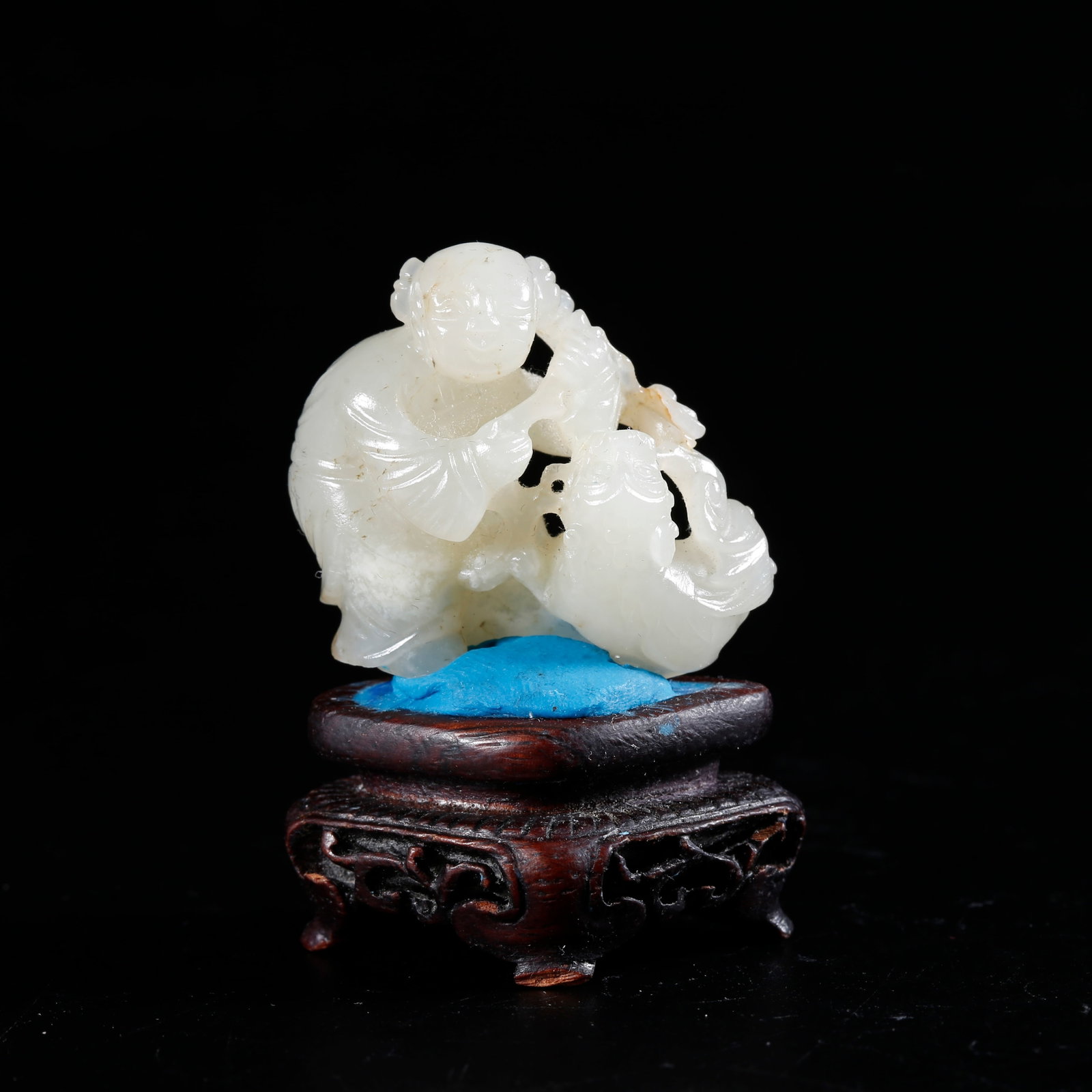 A HETIAN JADE CARVED ORNAMENT OF BOY PLAYING WITH LION: Hetian Jade Carved Ornament of Boy Playing with Lion