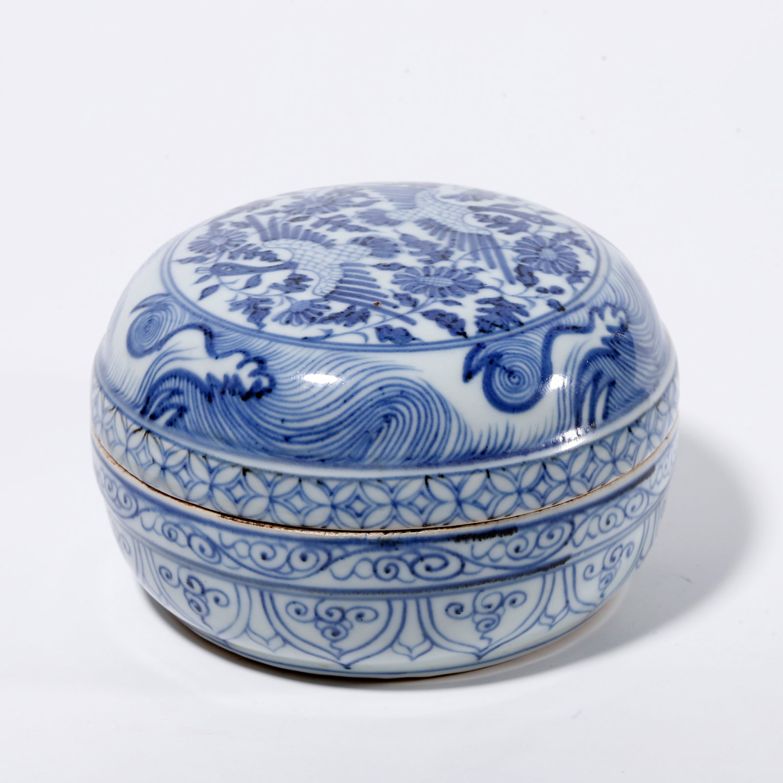 A BLUE AND WHITE LIDDED BOX WITH PHOENIX AMIDST FLORAL PATTERN: Blue and White Lidded Box with Phoenix Amidst Floral Pattern