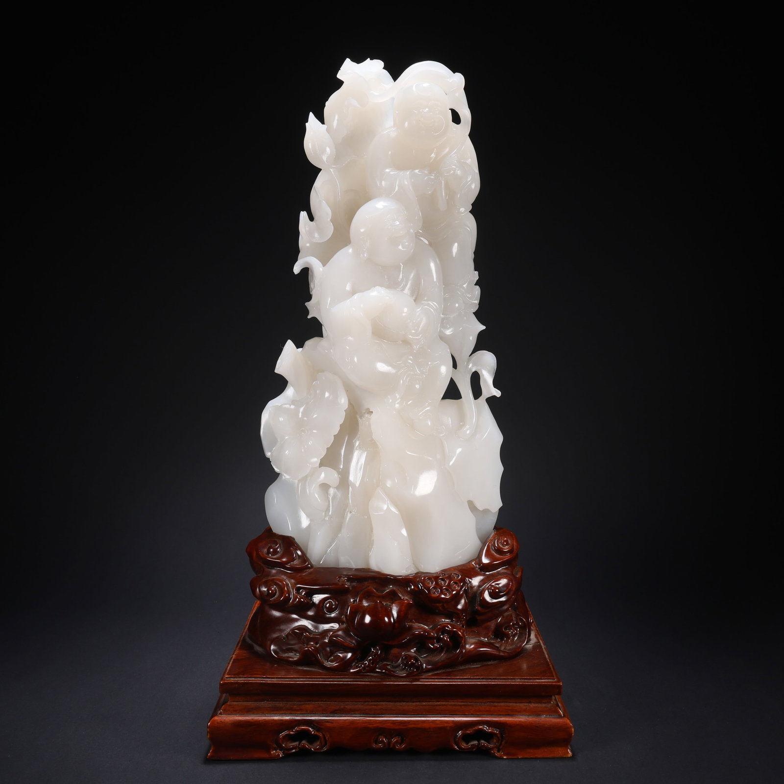 A HETIAN JADE WOODEN-BASE HARMONIOUS LOTUS BIRTH ORNAMENT (1 of 9)