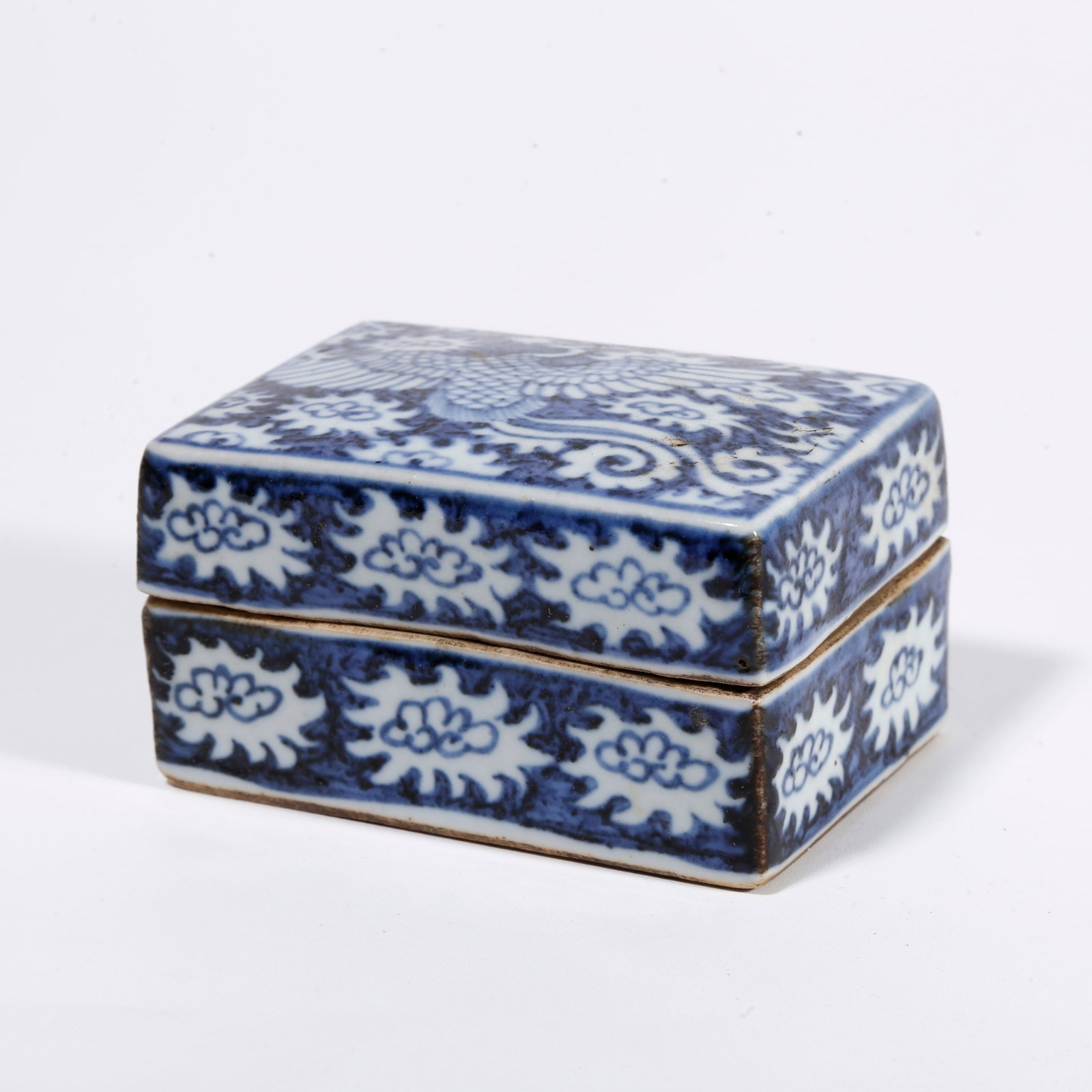 A BLUE AND WHITE LIDDED BOX WITH PHOENIX AMIDST FLORAL PATTERN: Blue and White Lidded Box with Phoenix Amidst Floral Pattern
