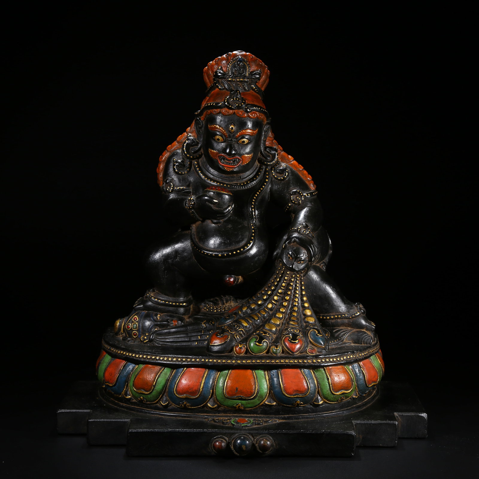 A BLACK STONE STATUE OF BLACK JAMBHALA: Black Stone Statue of Black Jambhala