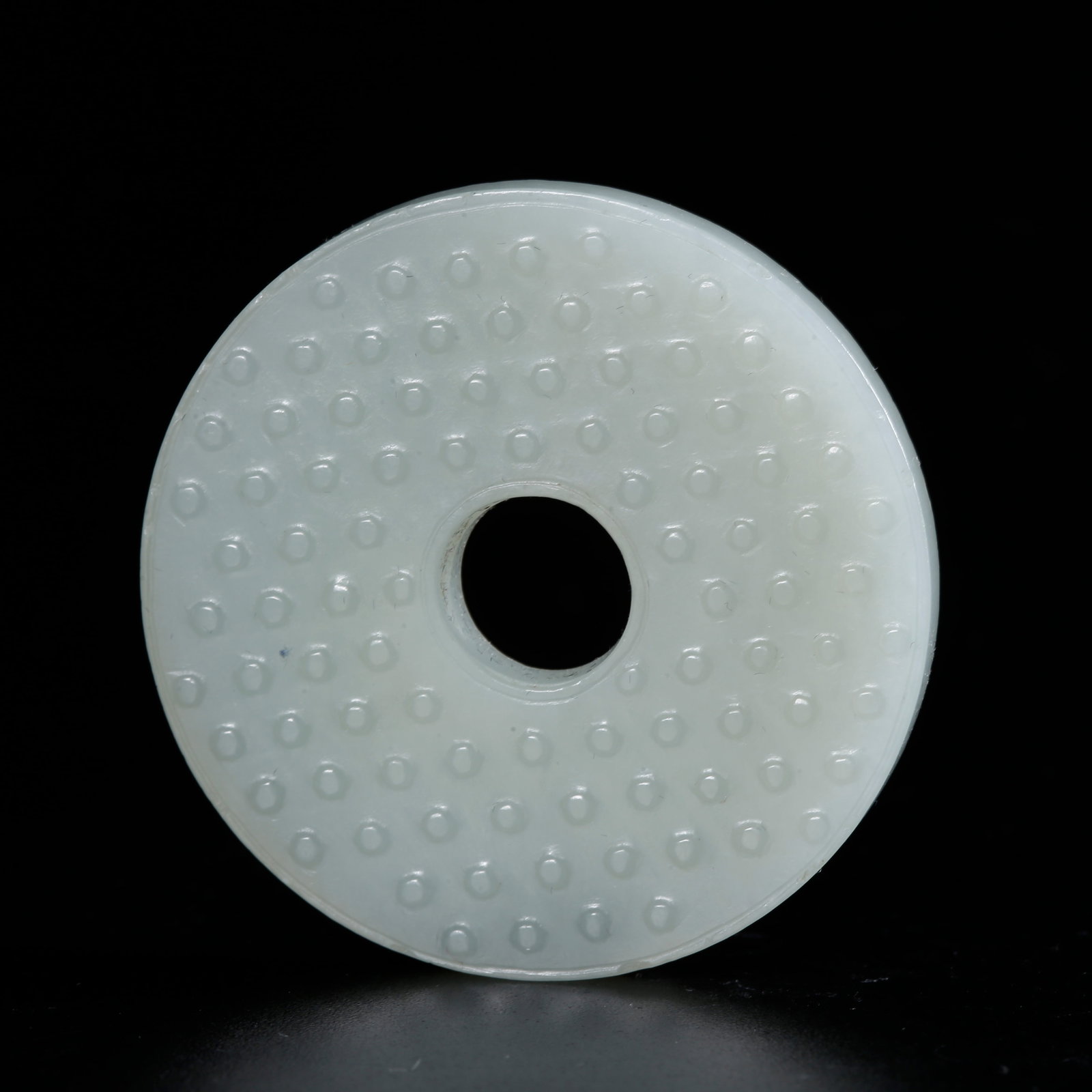 A HETIAN JADE CARVED BI DISC WITH STUD PATTERN: Hetian Jade Carved Bi Disc with Stud Pattern