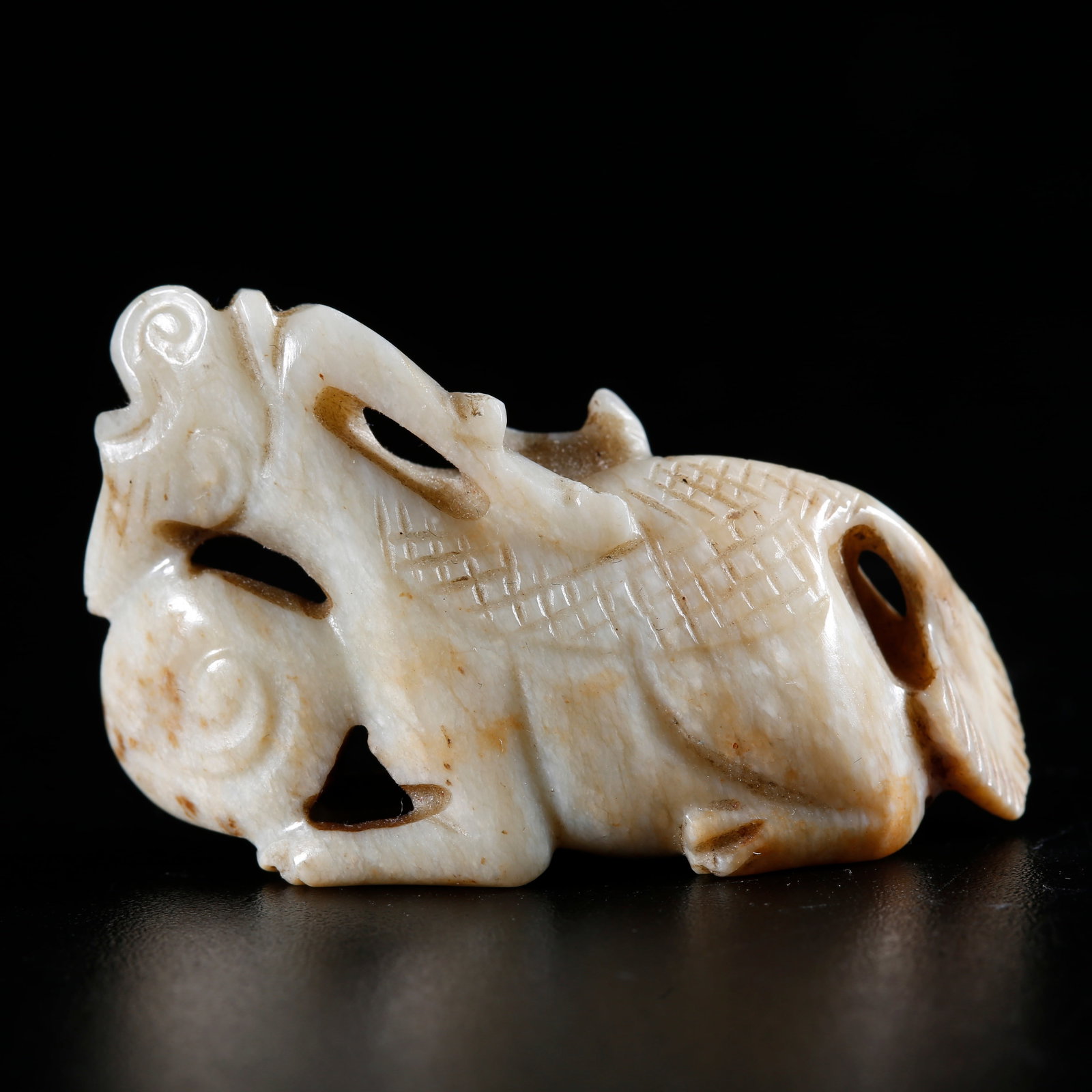 A HETIAN JADE CARVED QILIN-SHAPED ORNAMENT (1 of 9)