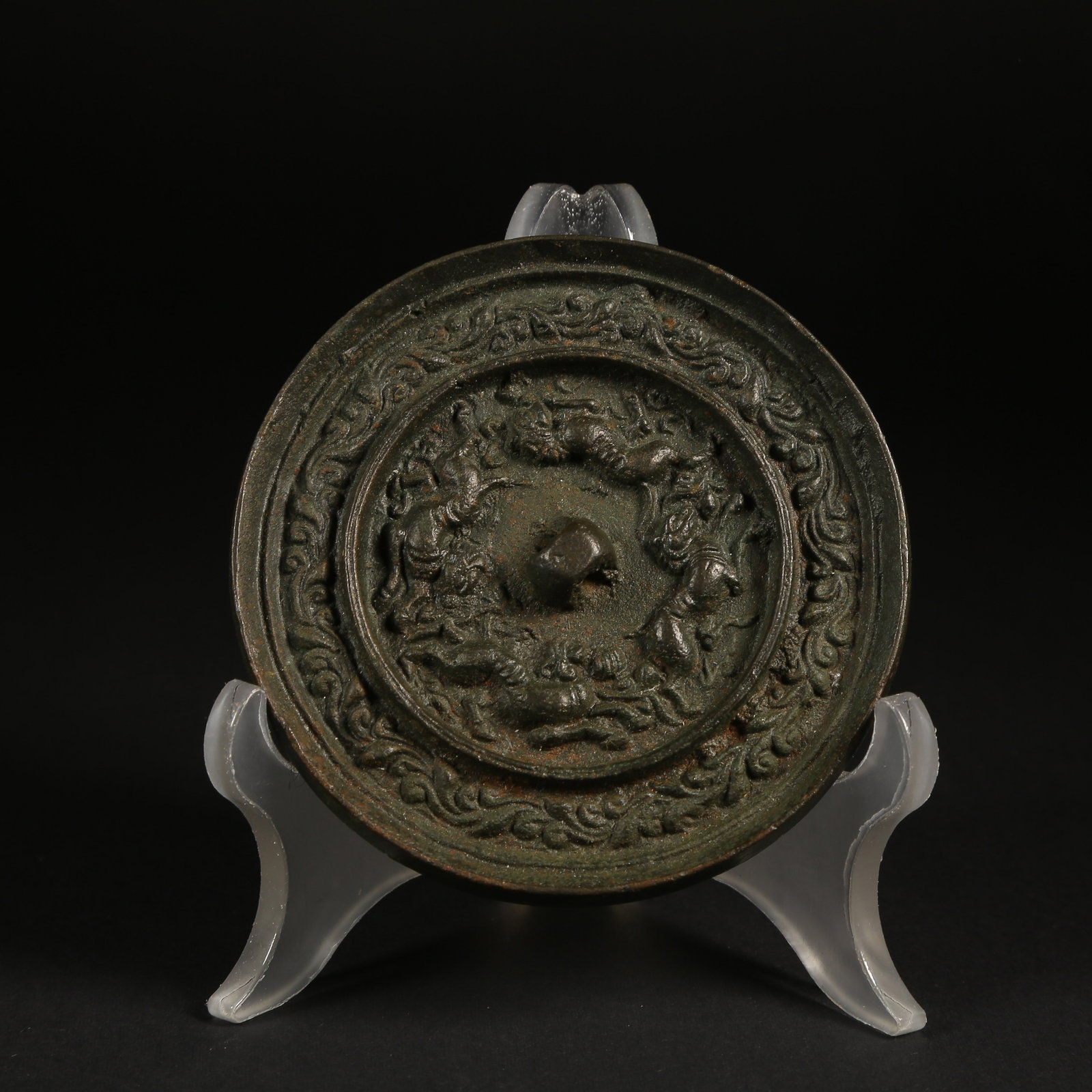 A BRONZE MIRROR WITH RUNNING BEAST AND BRANCHING FLORAL PATTERN: Bronze Mirror with Running Beast and Branching Floral Pattern
