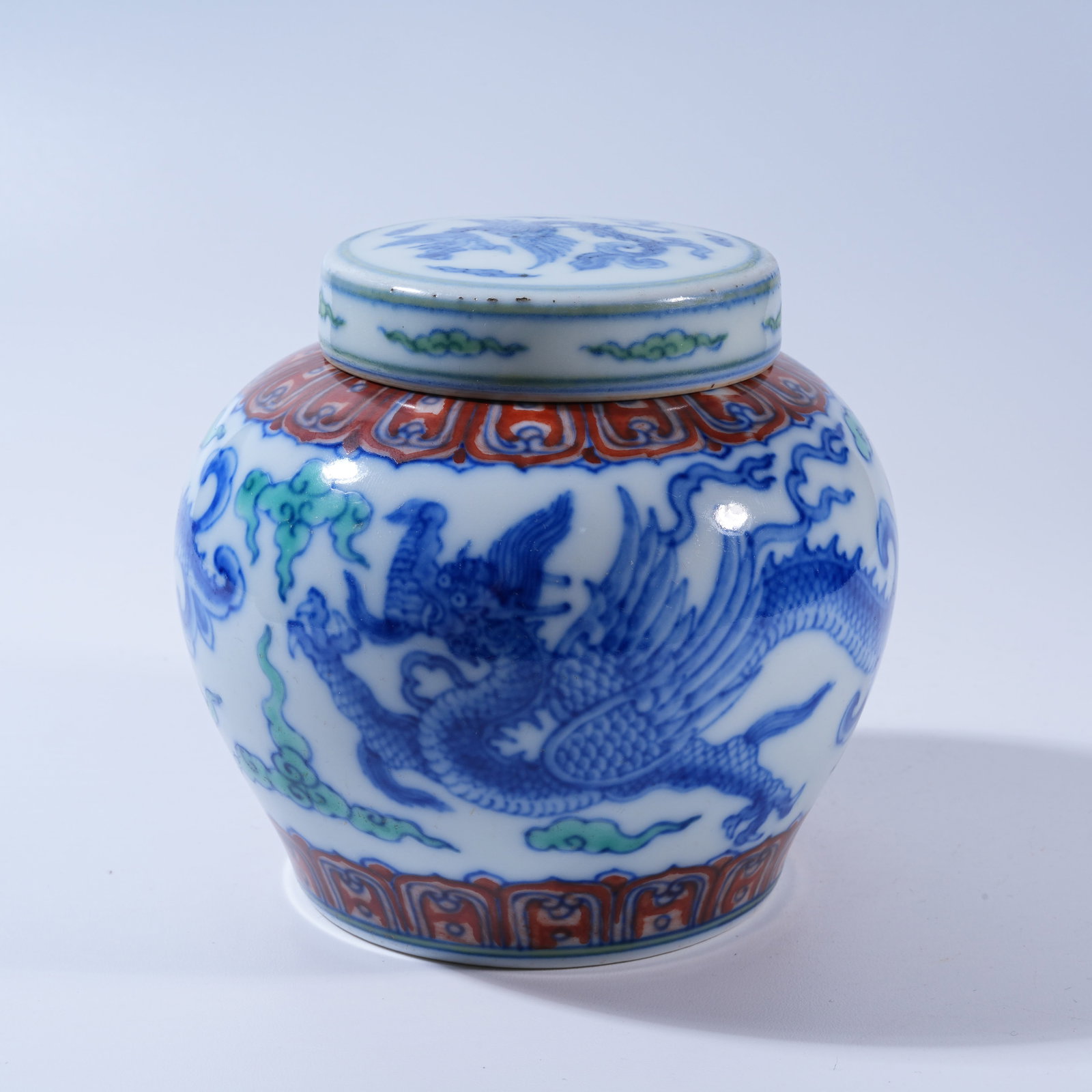 A BLUE-AND-WHITE DOUCAI "TIAN" JAR WITH CLOUD AND DRAGON DESIGN: Blue-and-White Doucai "Tian" Jar with Cloud and Dragon Design