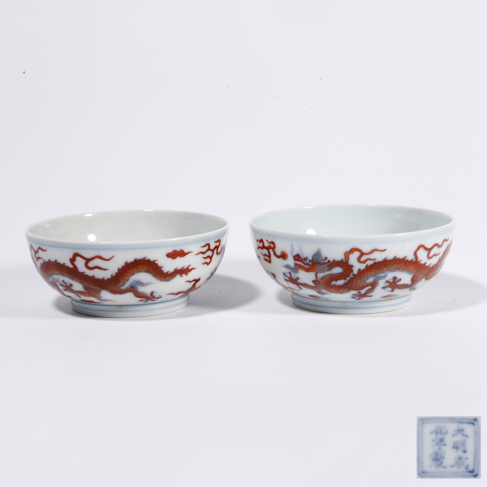 A PAIR OF IRON-RED CUPS WITH DOUBLE DRAGON PLAYING WITH PEARL PATTERN: Pair of Iron-red Cups with Double Dragon Playing with Pearl Pattern