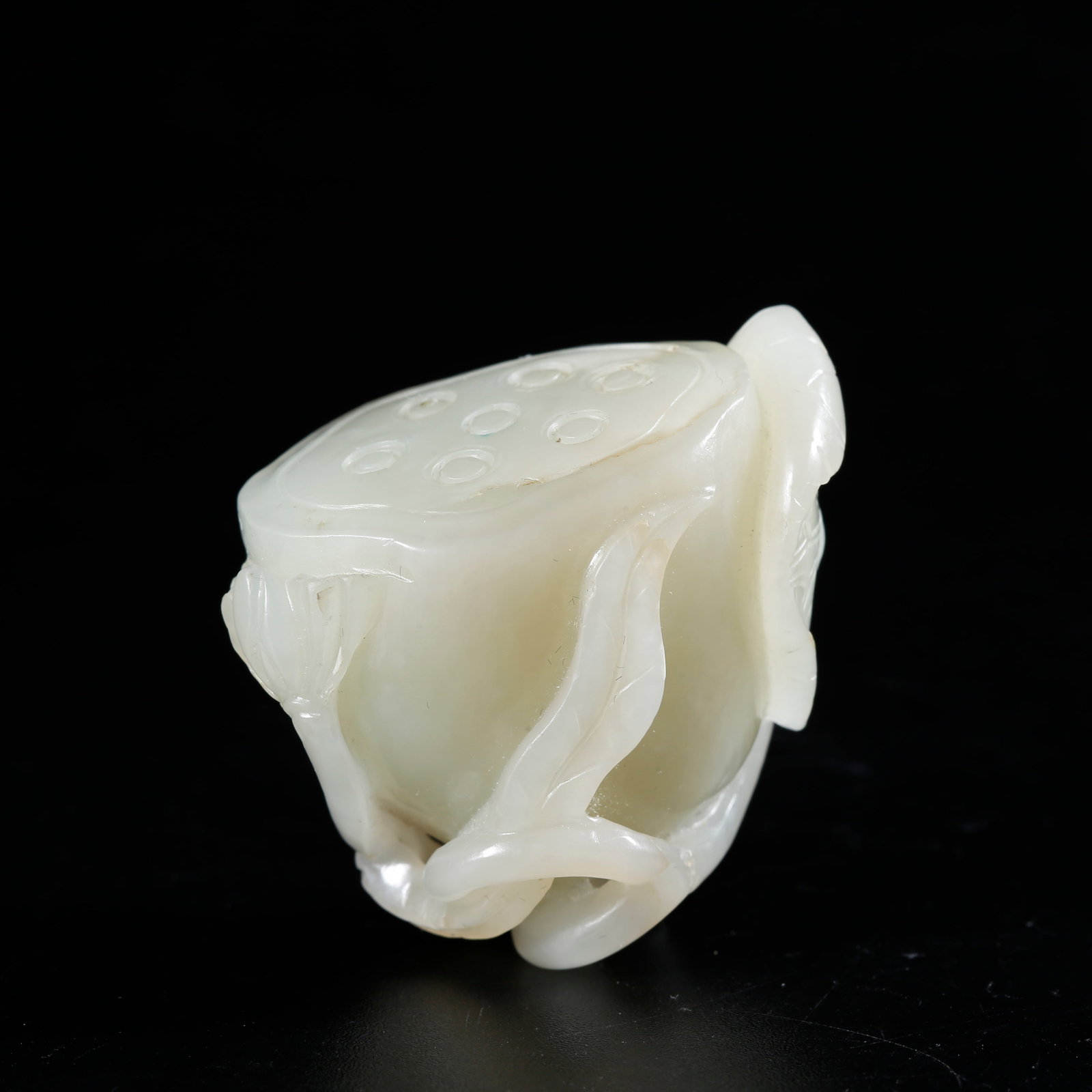 A HETIAN JADE CARVED LOTUS ROOT-SHAPED ORNAMENT: Hetian Jade Carved Lotus Root-shaped Ornament